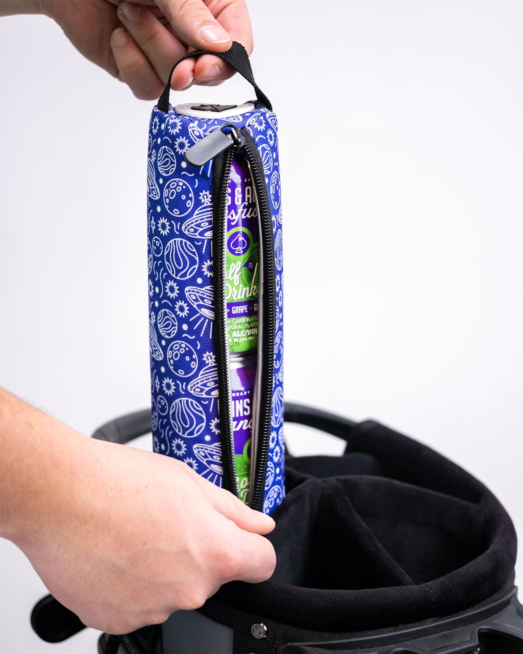 Alt text: HEYDUDE Beer Sleeve in Indigolactic design, featuring a vibrant blue pattern with cosmic elements, ideal for holding and insulating beverages.