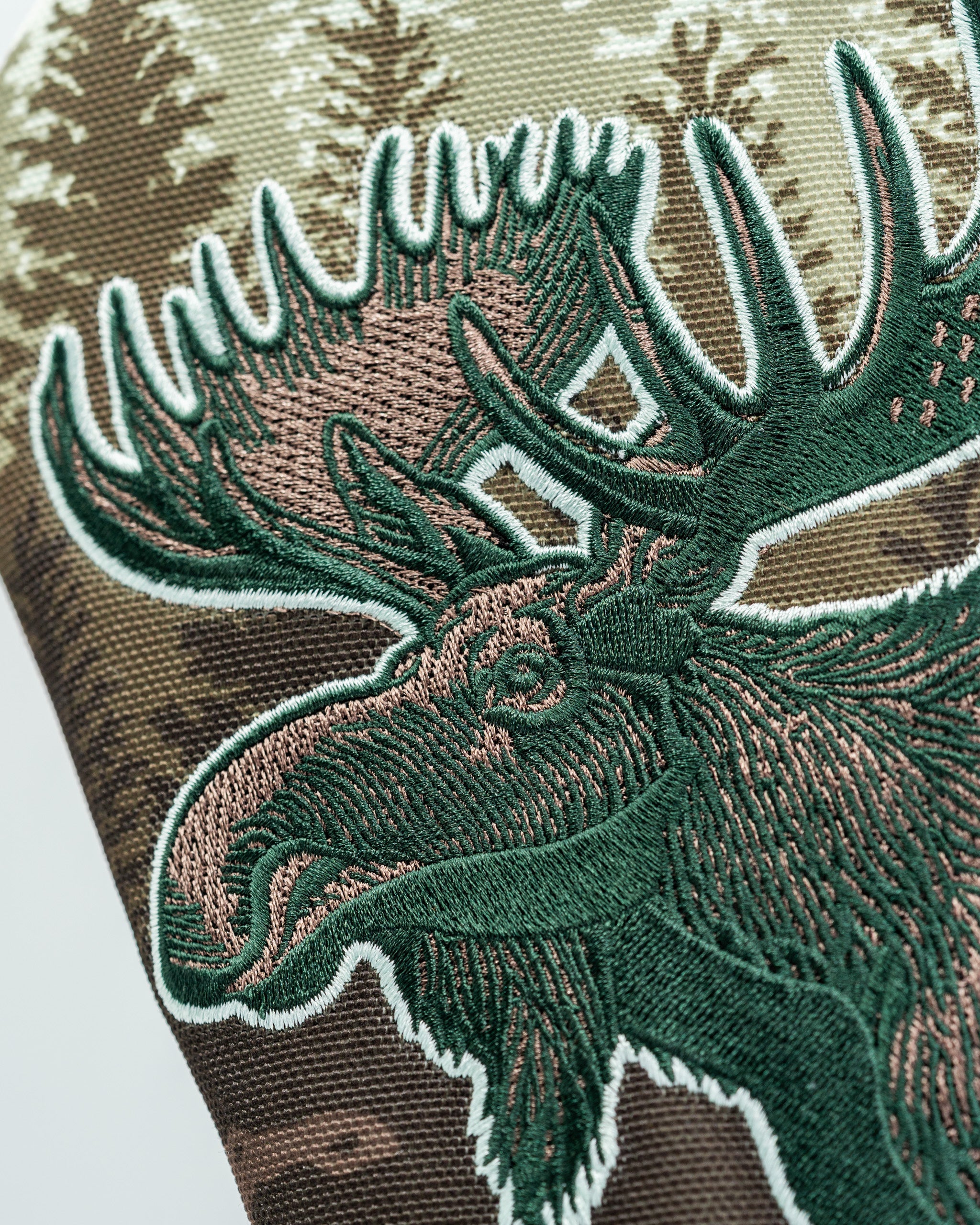 Moose driver cover featuring detailed embroidery on a camouflage background, perfect for bold golf enthusiasts.