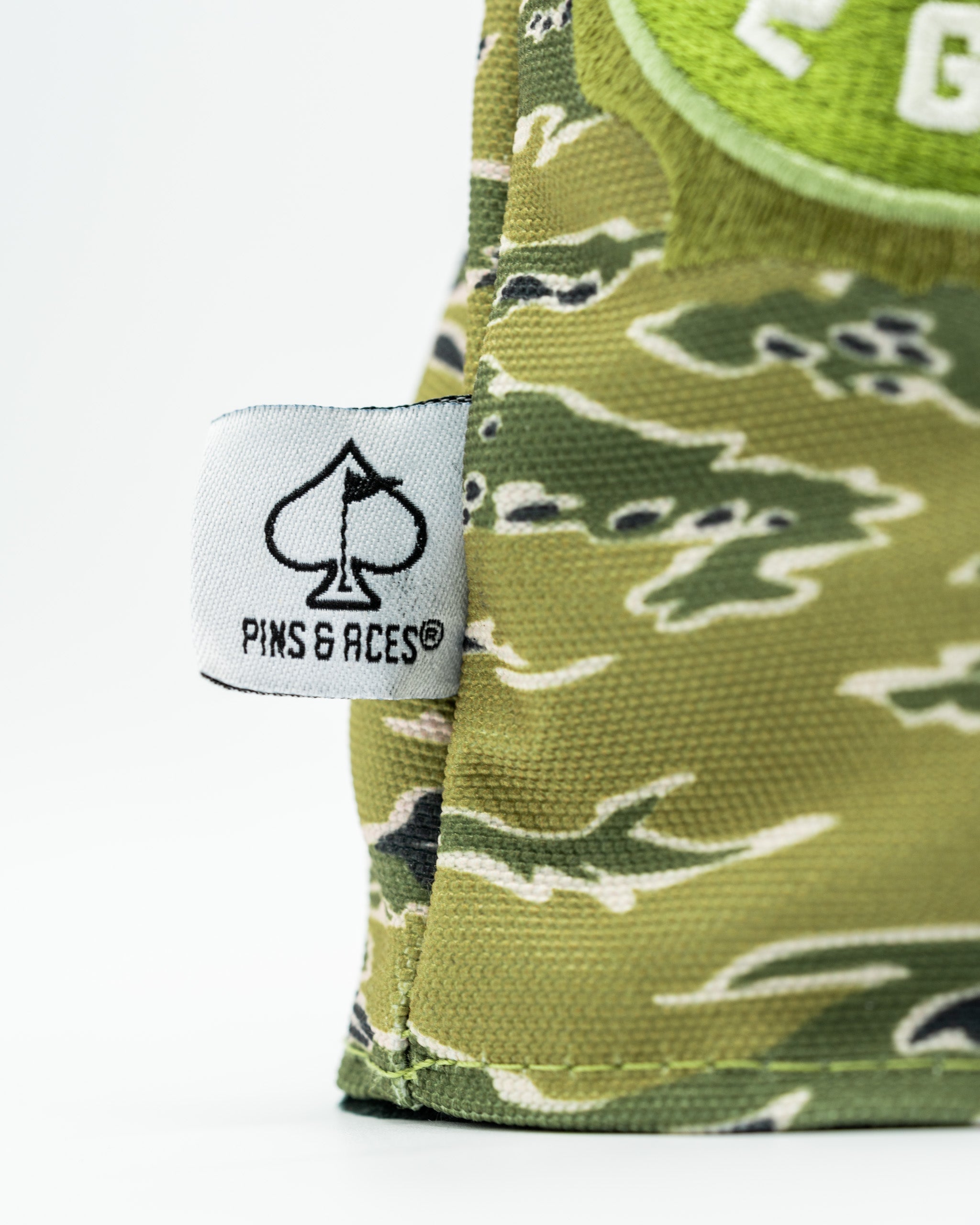 Camouflage driver cover featuring a mallard design and Pins & Aces logo, perfect for stylish golfers.