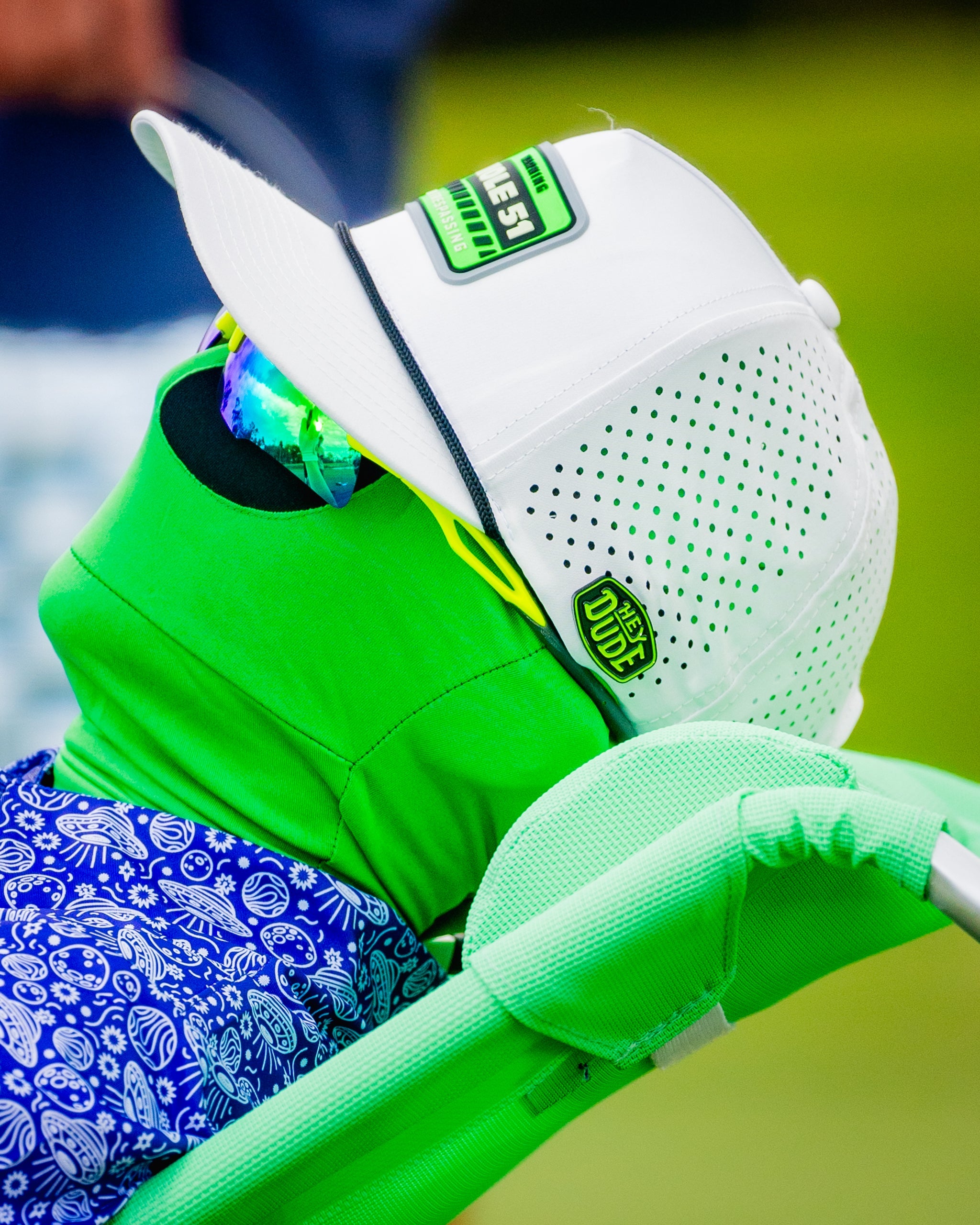 "HEYDUDE logo ball marker featuring a circular design with vibrant colors."