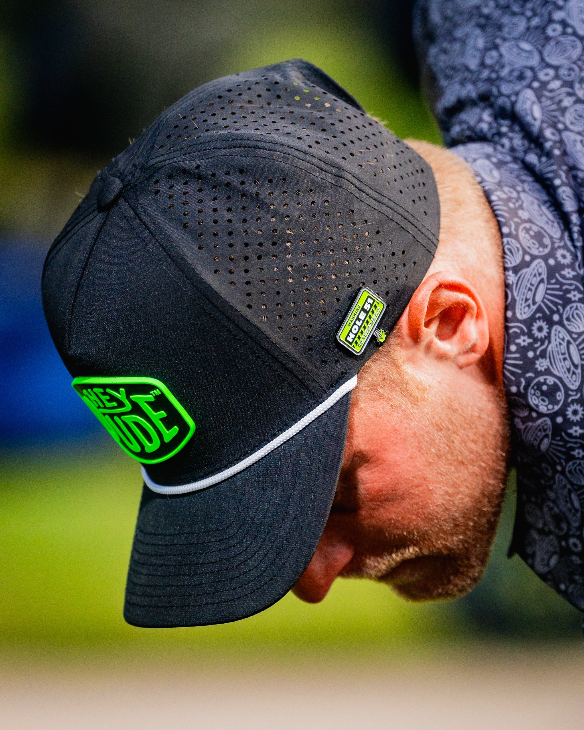 HEYDUDE Hole 51 Ball Marker featuring a sleek design and vibrant colors, perfect for golfers looking to personalize their game.