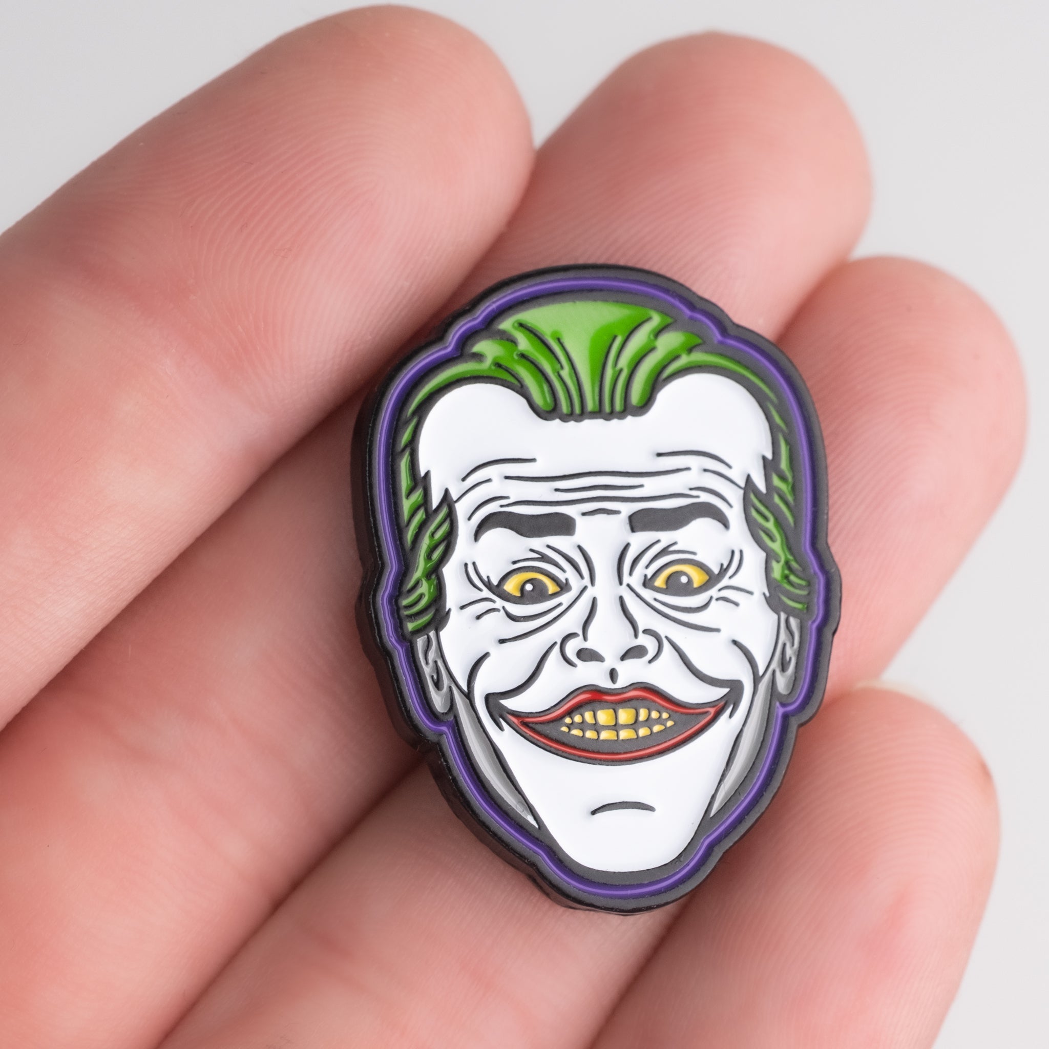 Joker Ball Marker 3.0 held in hand, featuring a vibrant joker design for golf enthusiasts.