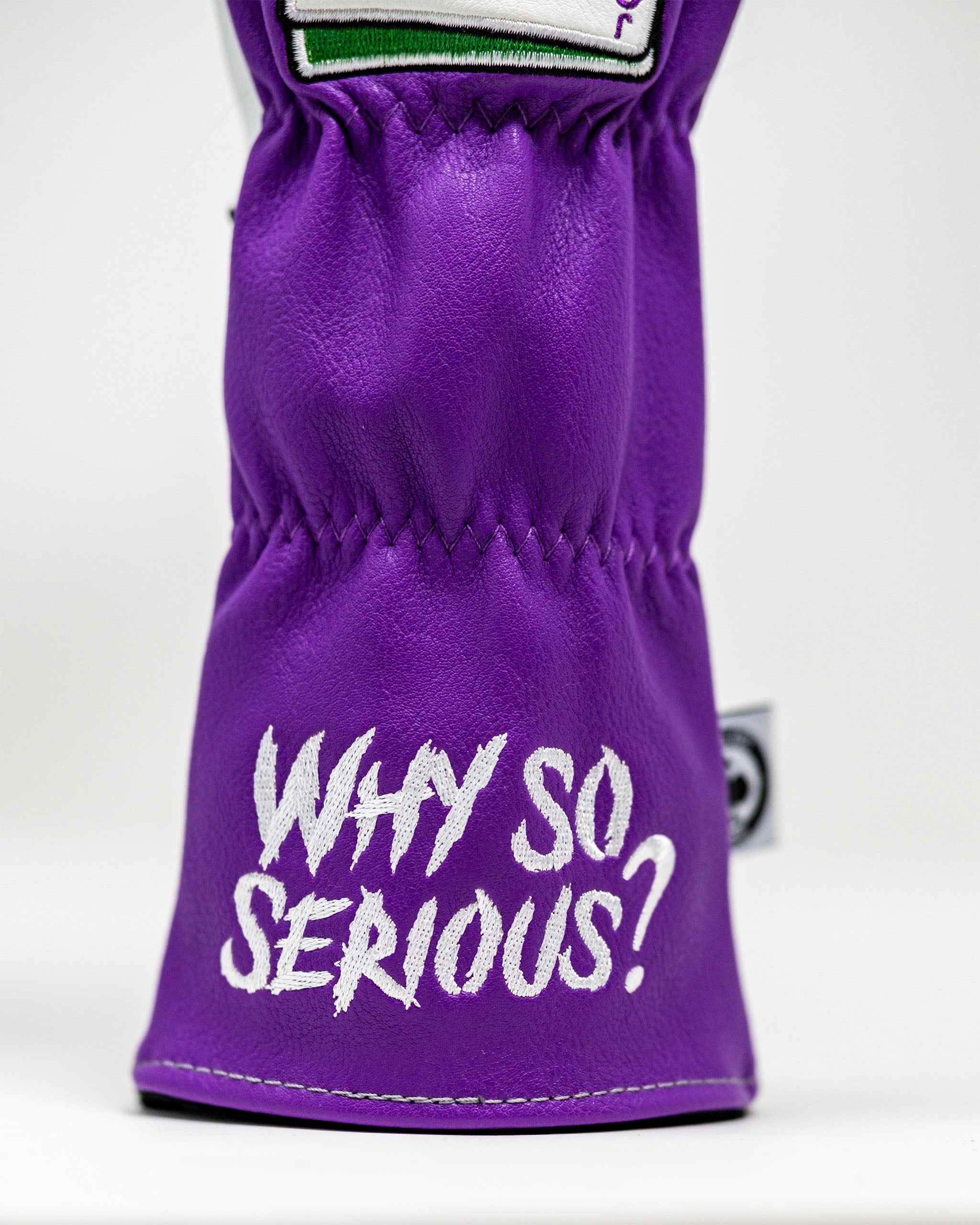 Purple leather golf headcover with "WHY SO SERIOUS?" embroidered in white, bold, playful font. Perfect for bold golf style.