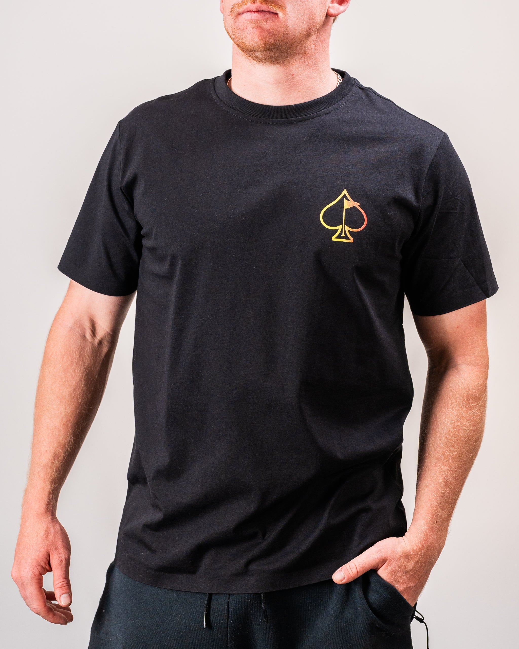 Half&Half tee shirt displayed on a model outdoors, featuring a divided color design in shades of black and white, with casual styling suitable for everyday wear.