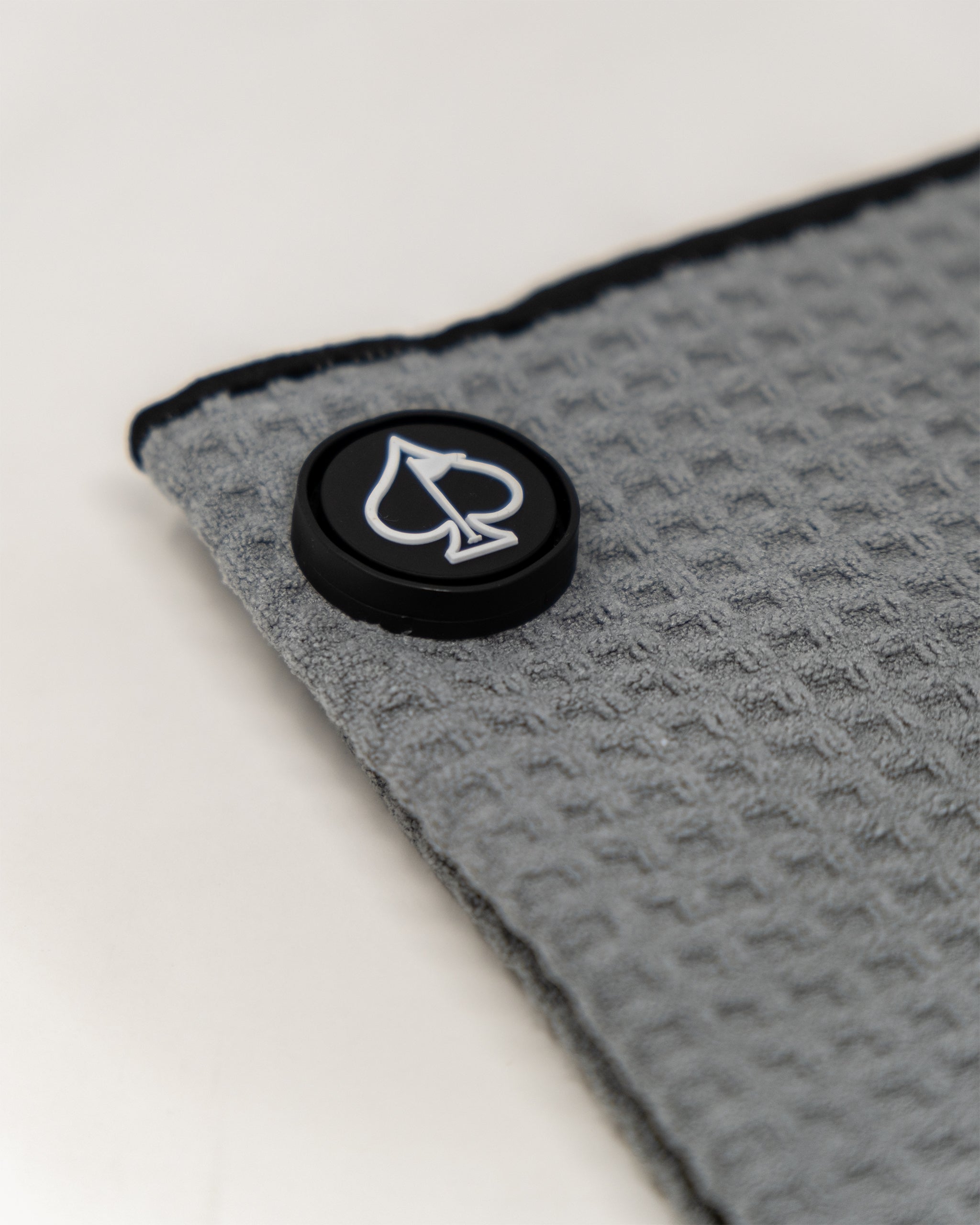 Gray magnetic towel with a sleek design, featuring a compact size for easy storage and a strong magnetic closure, ideal for gym or outdoor use.