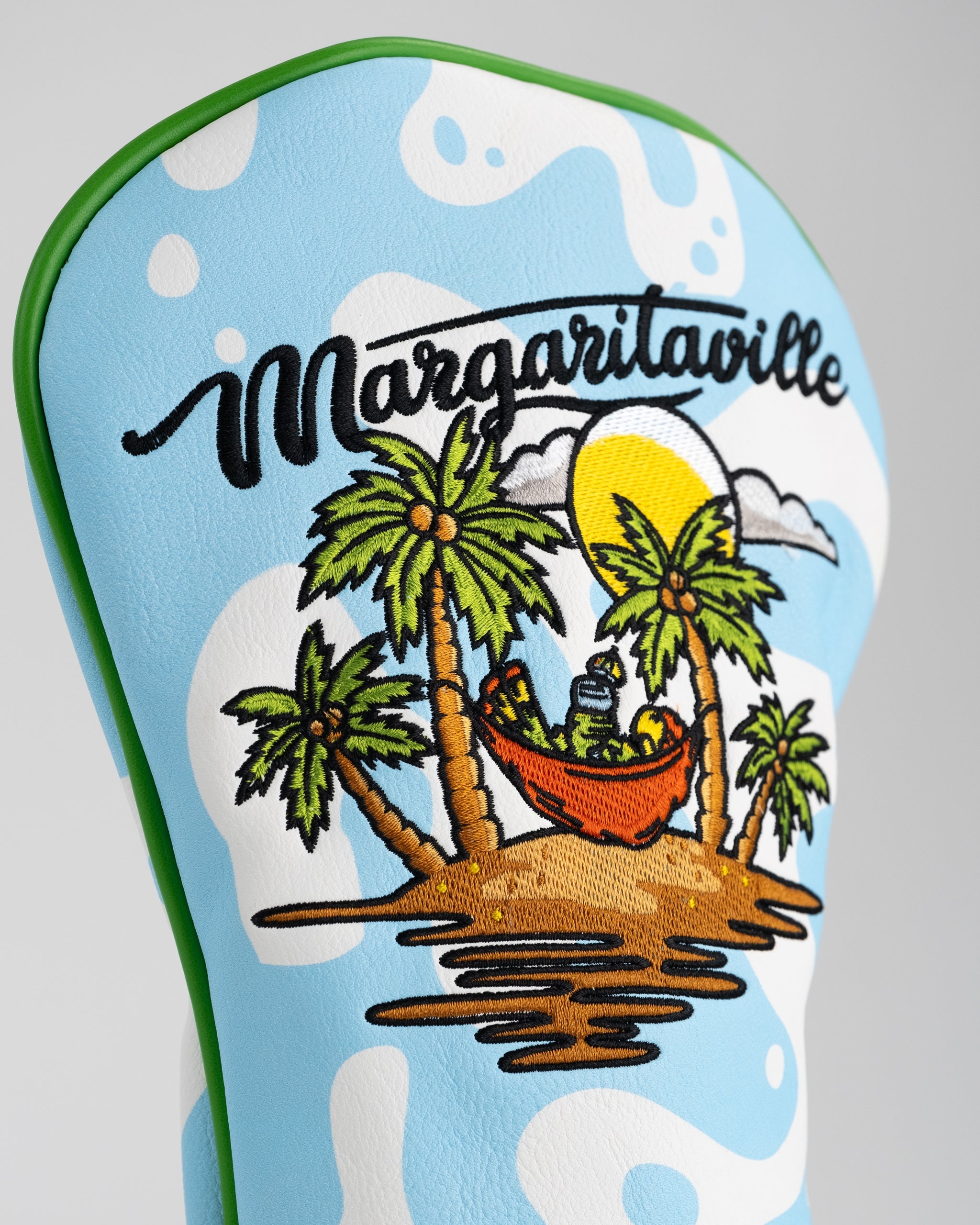 Margaritaville golf driver cover featuring a vibrant tropical design with a parrot and palm tree motifs.