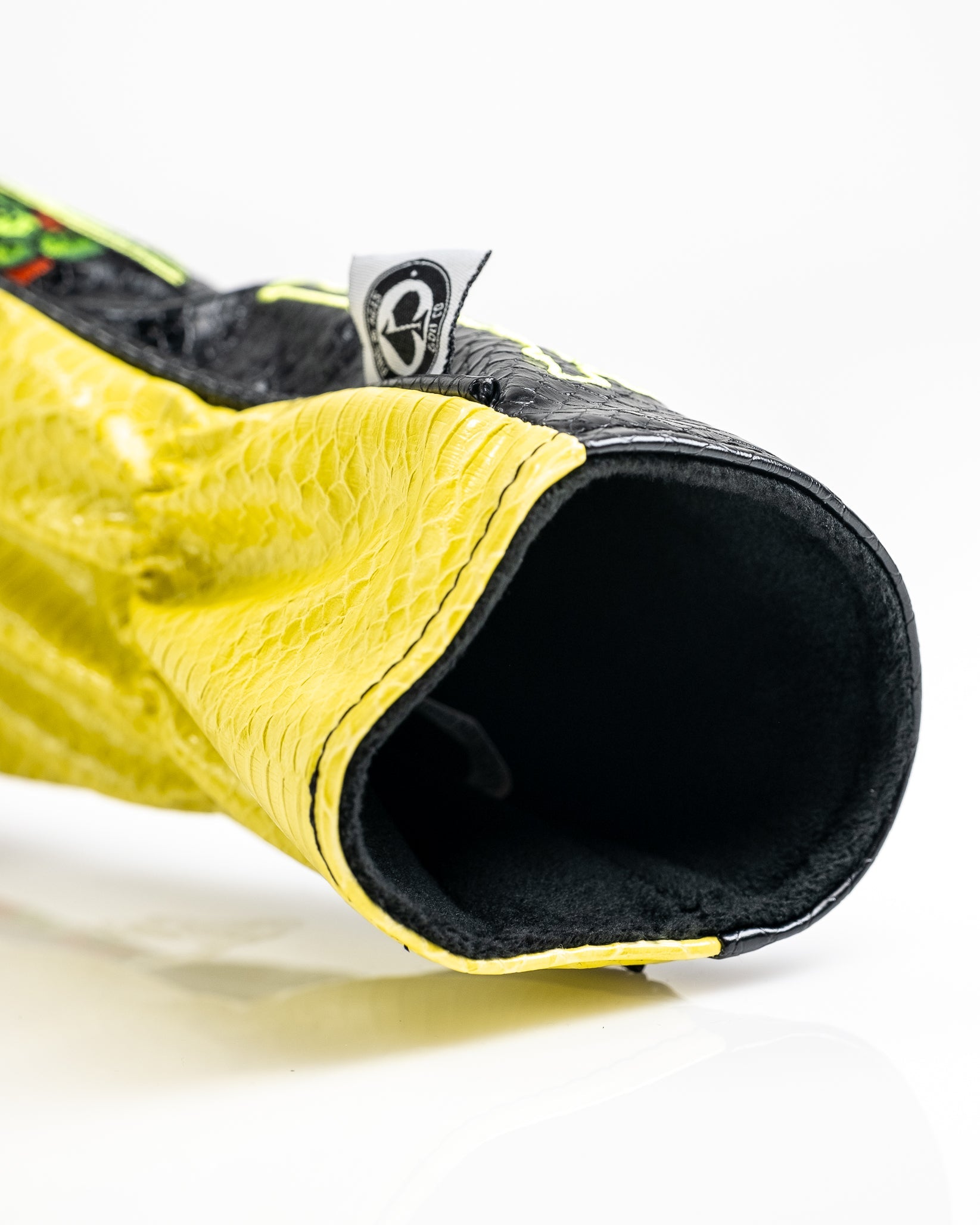 Close-up of a bold yellow and black golf headcover with textured snakeskin pattern, designed for standout golf style.