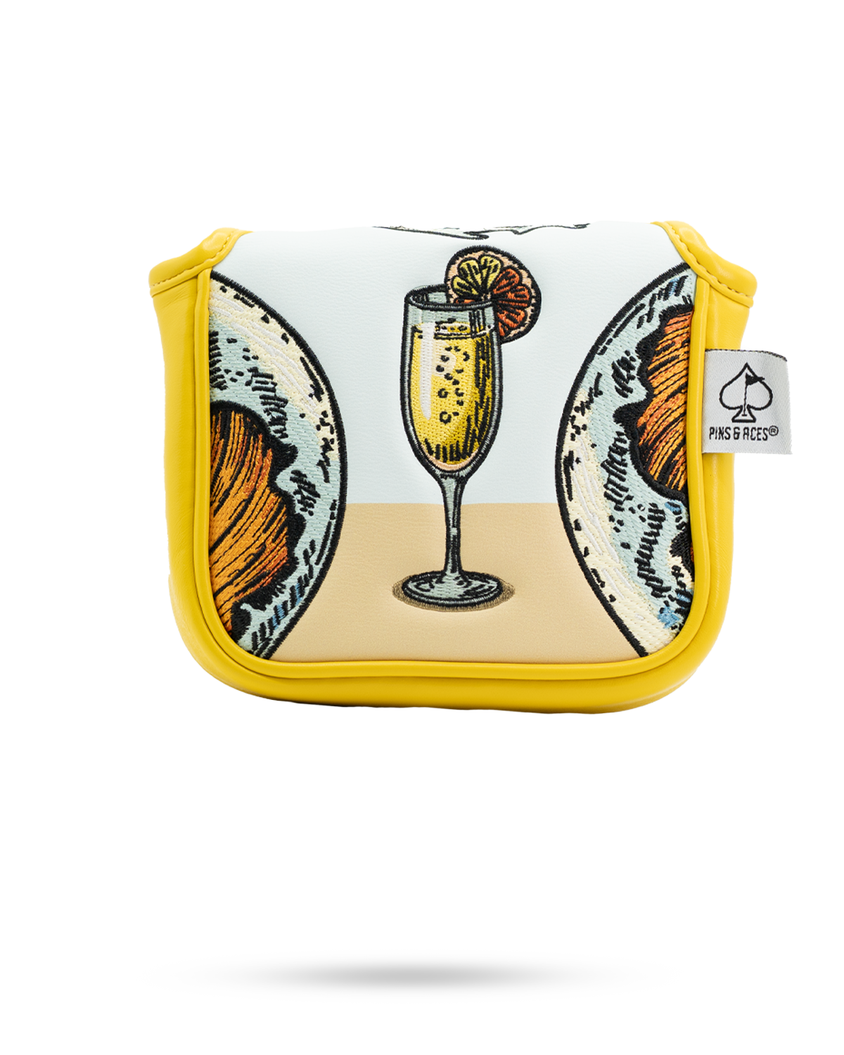 Mimosa mallet putter cover featuring a vibrant design of a cocktail glass and brunch items on a yellow background.