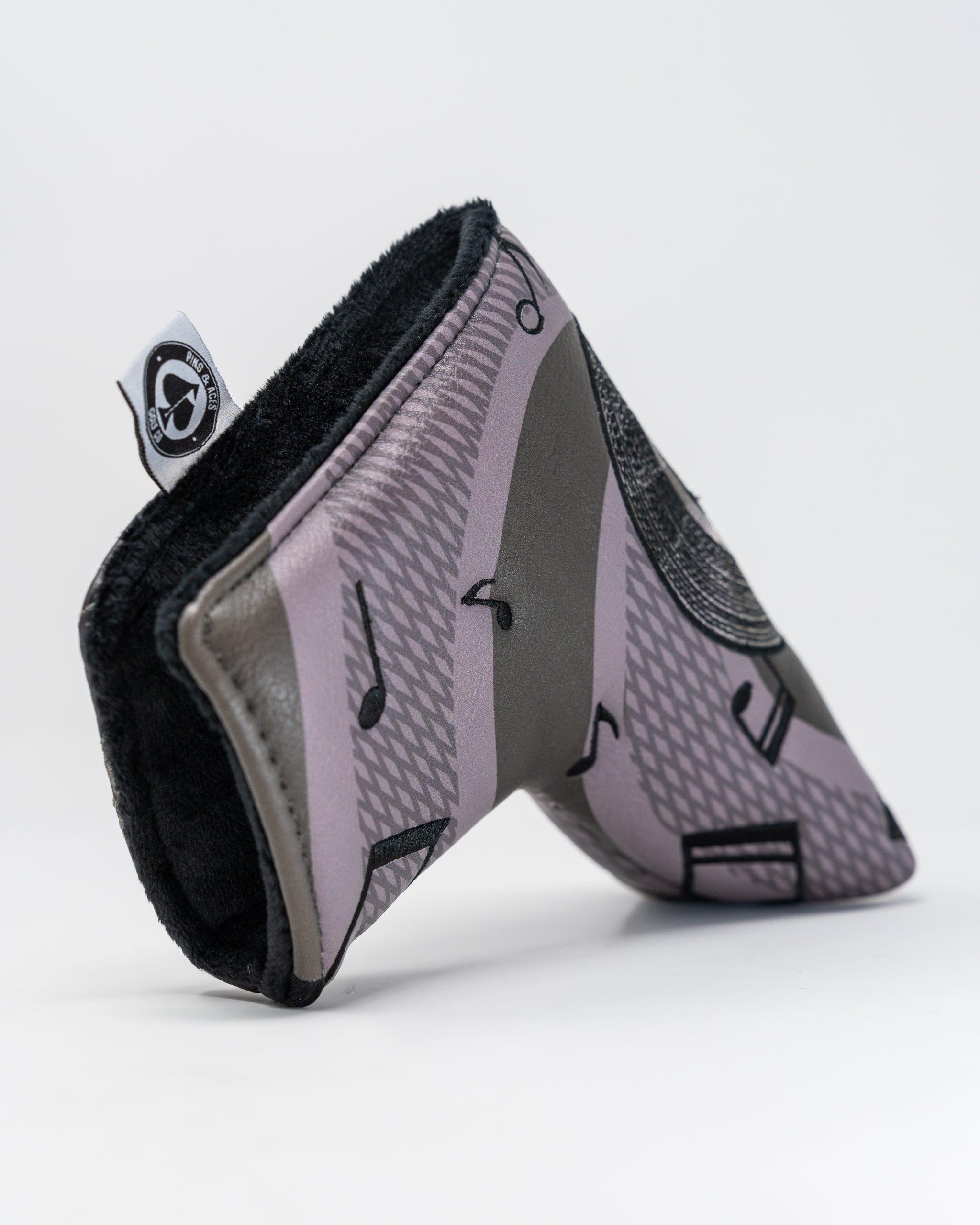 Music City Blade Putter Cover featuring a vibrant design with musical notes and a sleek black background.