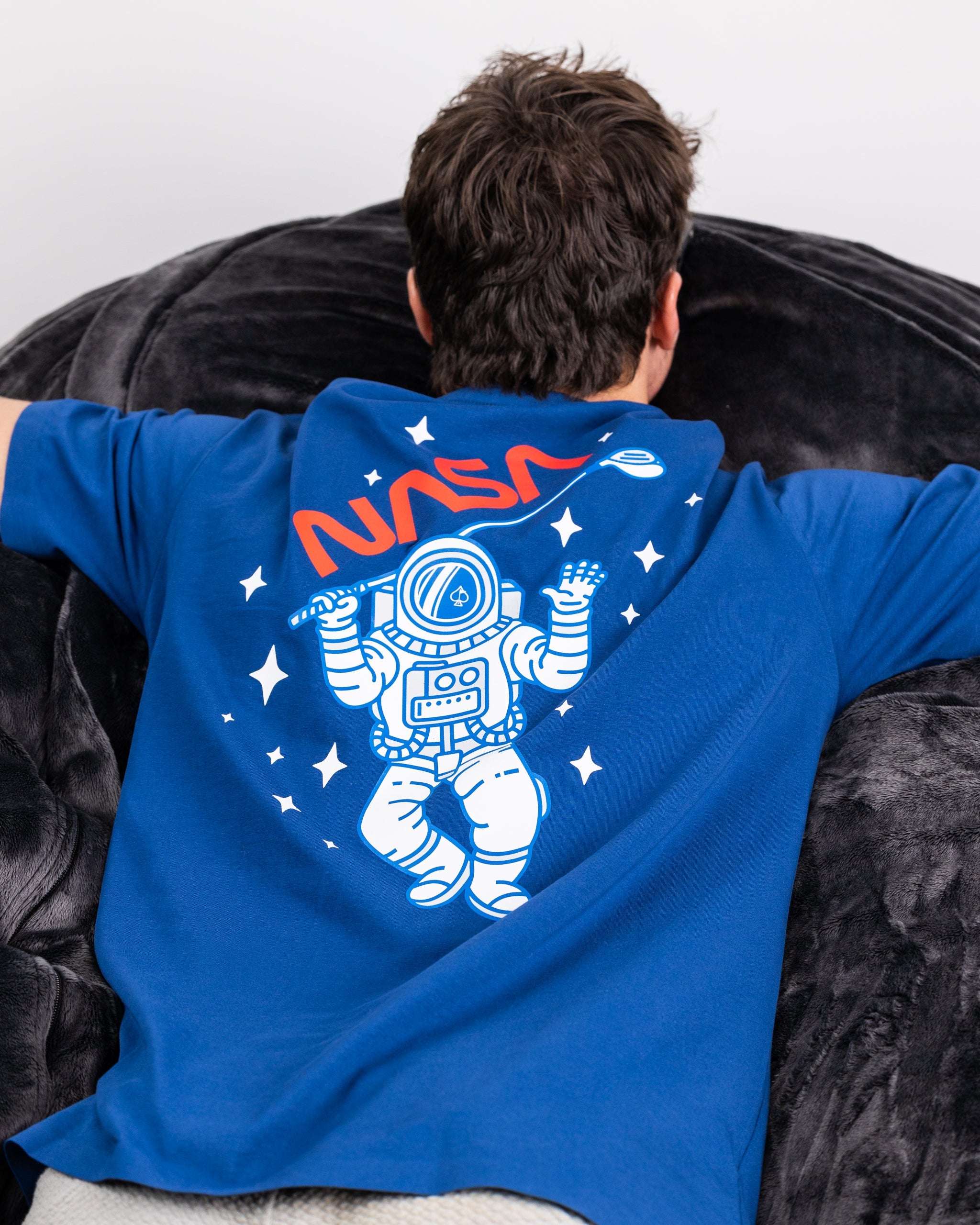 White NASA t-shirt featuring the iconic NASA logo in red and blue on the chest.