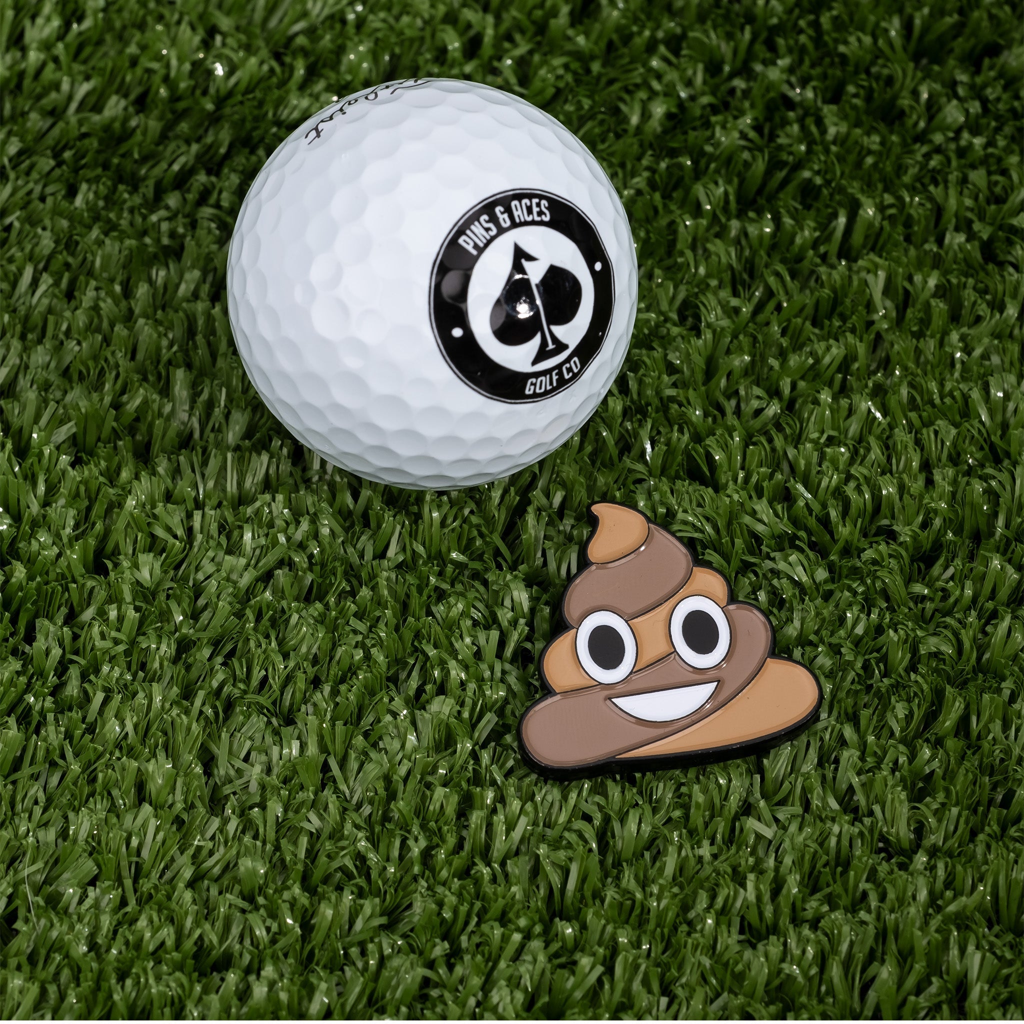 Novelty poop-themed golf ball marker with a smiling emoji design.