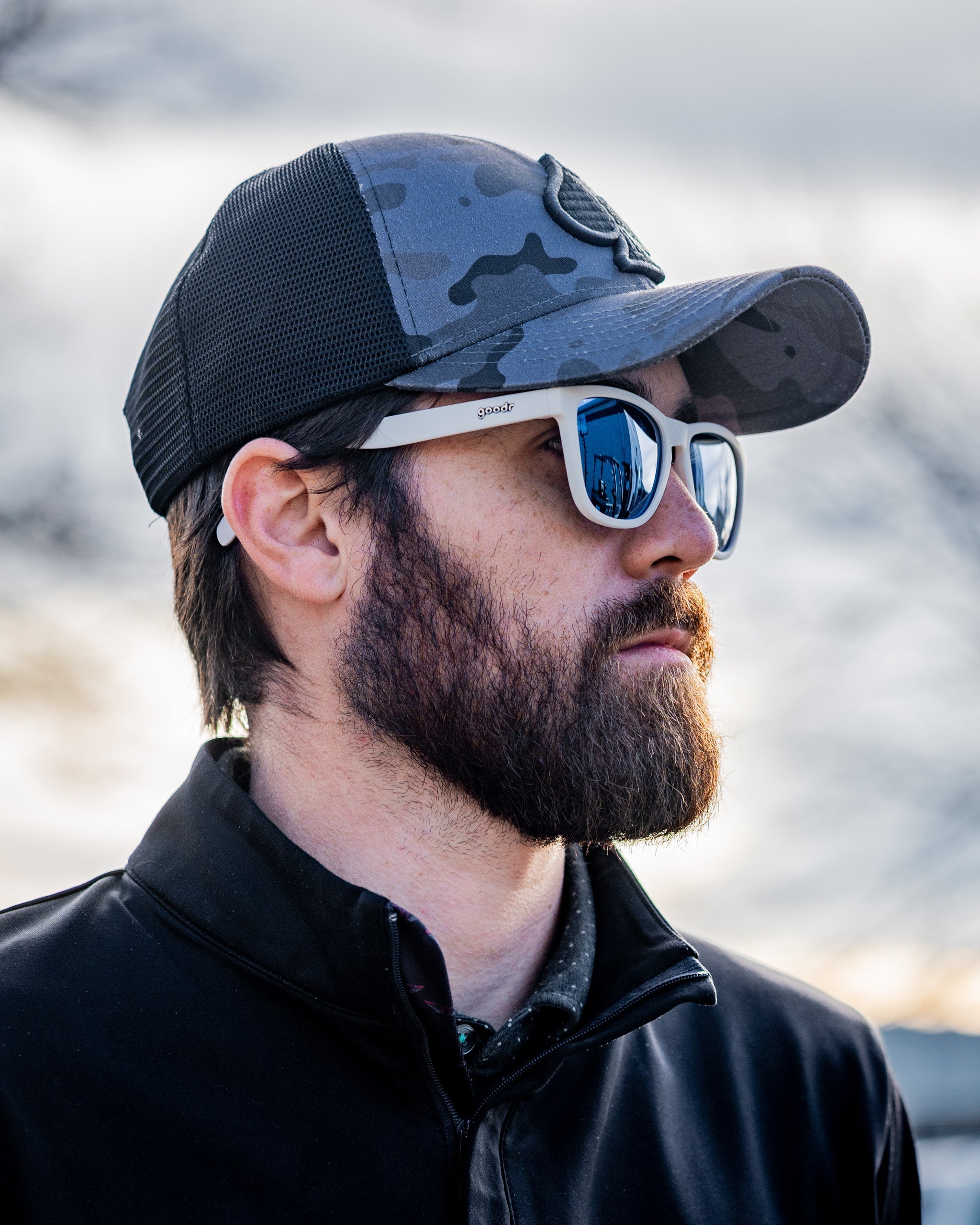 Urban camo trucker hat with mesh back and adjustable snap closure.