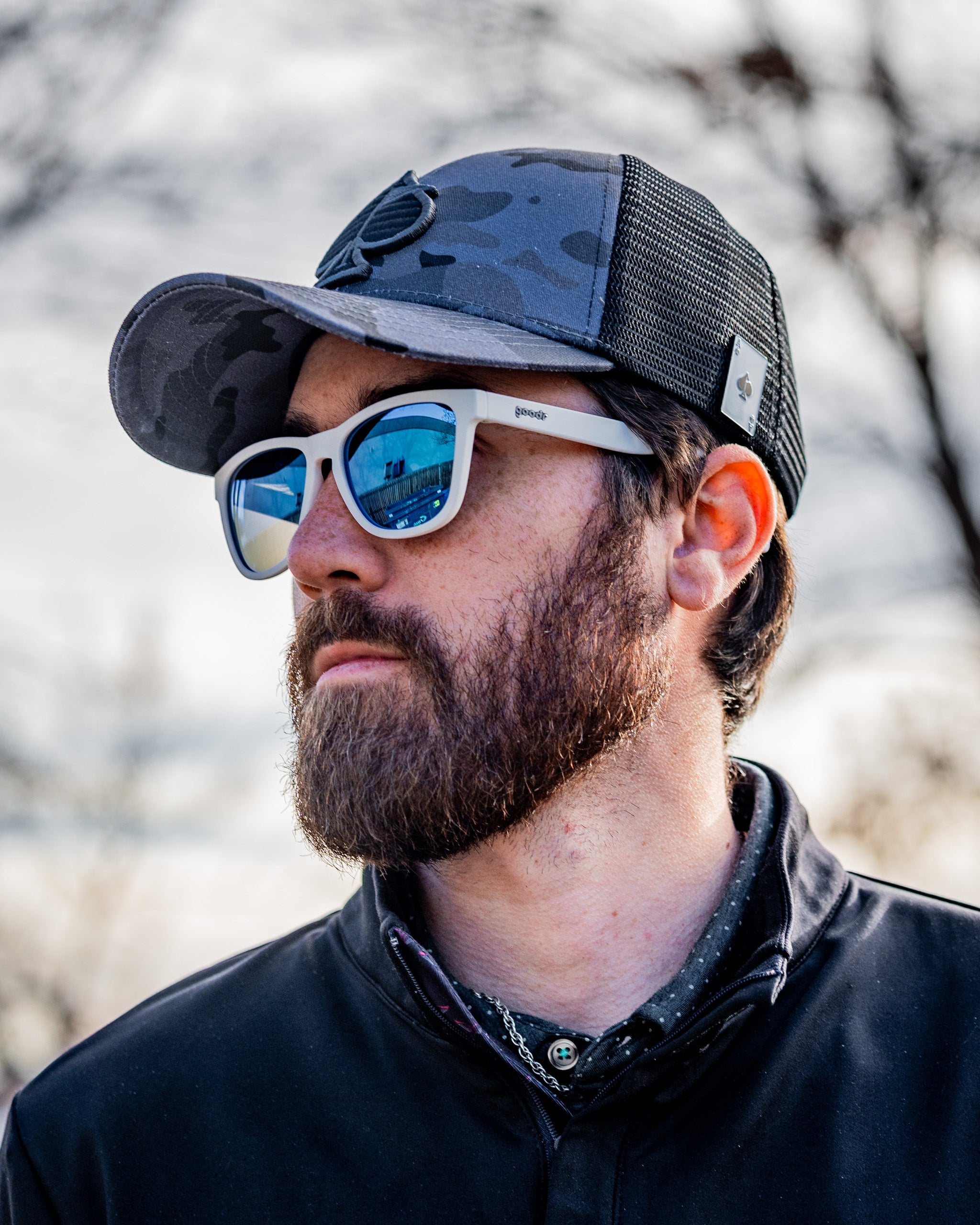 Urban camo trucker hat featuring a mesh back and adjustable strap.