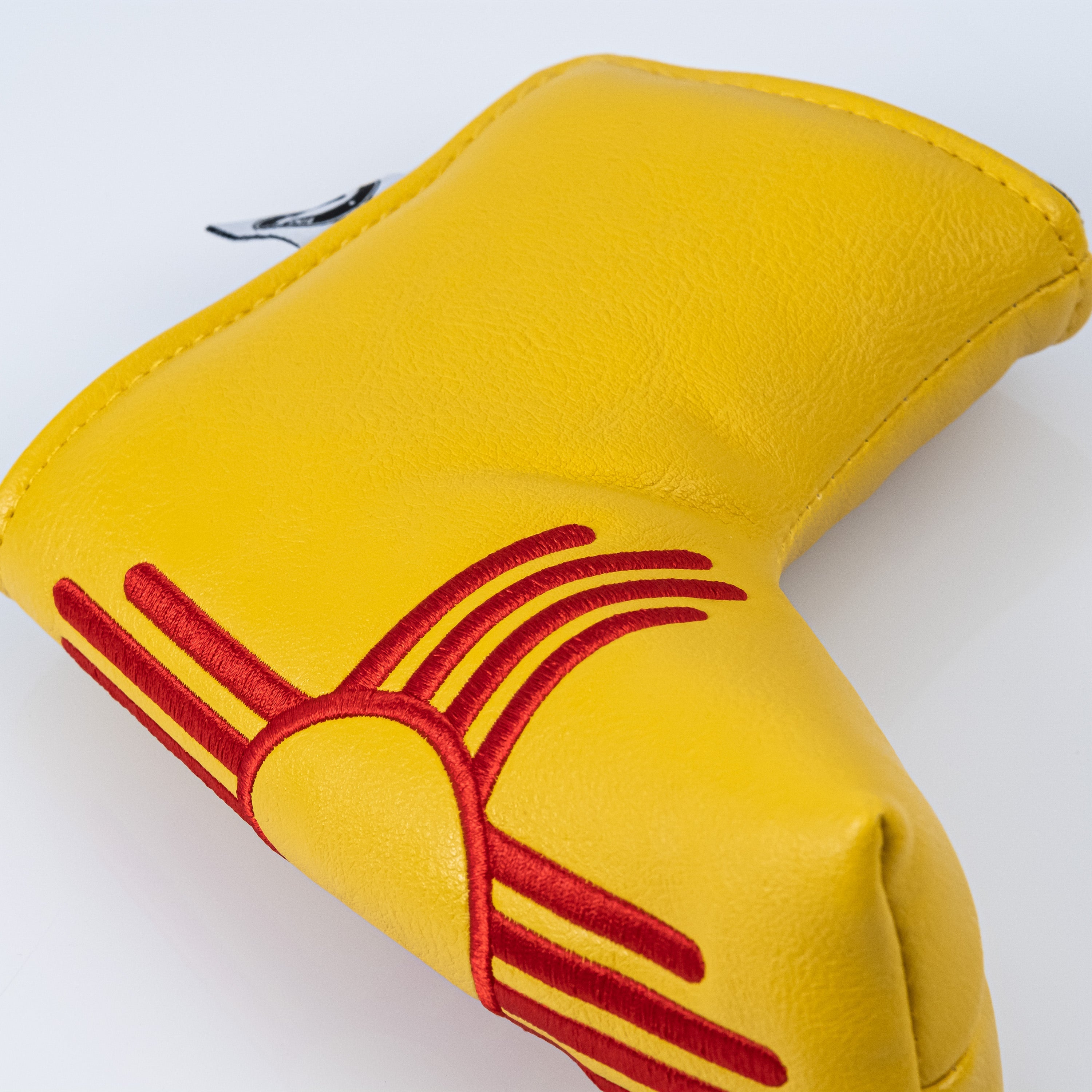 New Mexico State Flag Blade Putter Cover with vibrant red and yellow design.