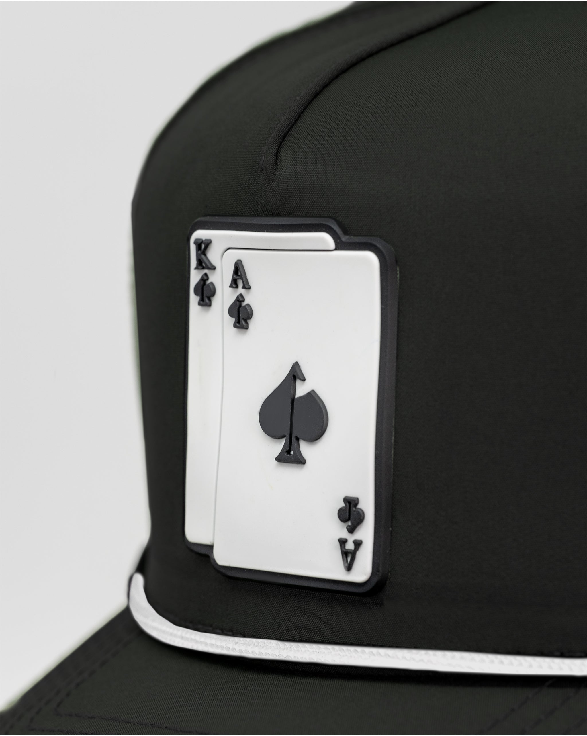 Black perforated rope hat featuring an AK patch.