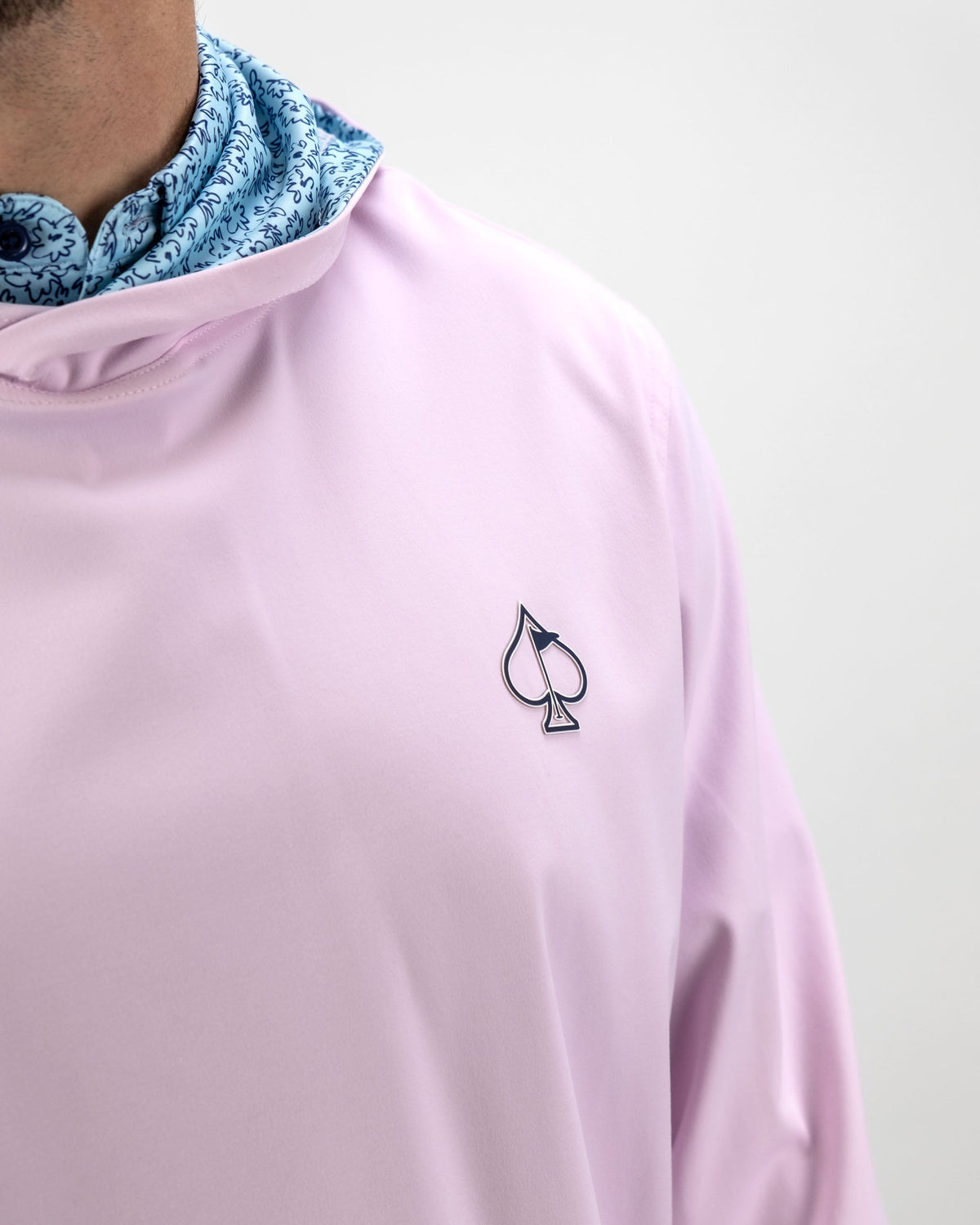 Light blue performance golf hoodie featuring a flower doodle design and a logo on the chest, perfect for stylish golfers.