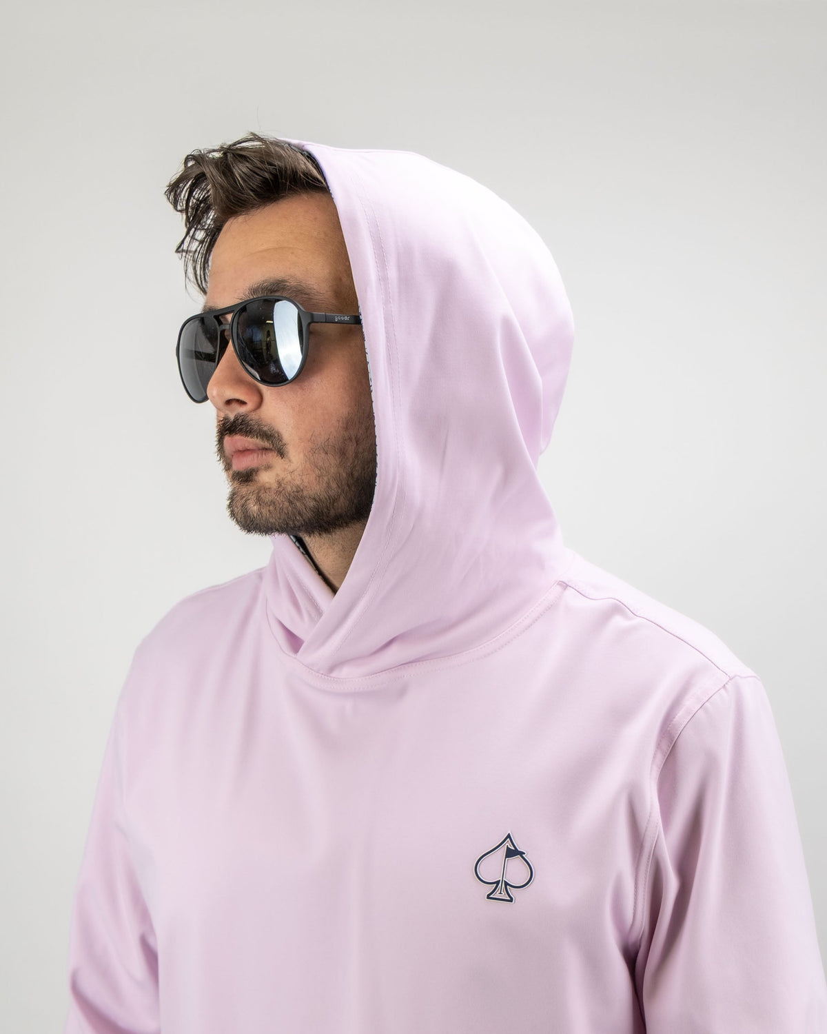 Men's performance golf hoodie in light pink with a flower doodle design and spade logo, perfect for stylish golfers.