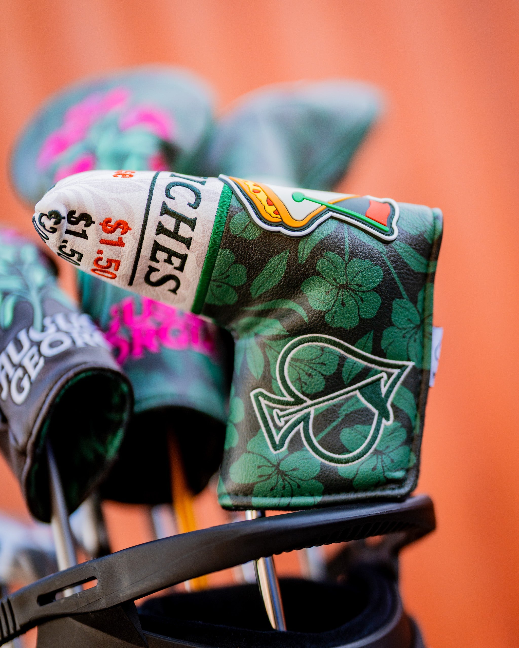 Augusta '25 Blade Putter Cover in vibrant green with logo, designed for golf enthusiasts.