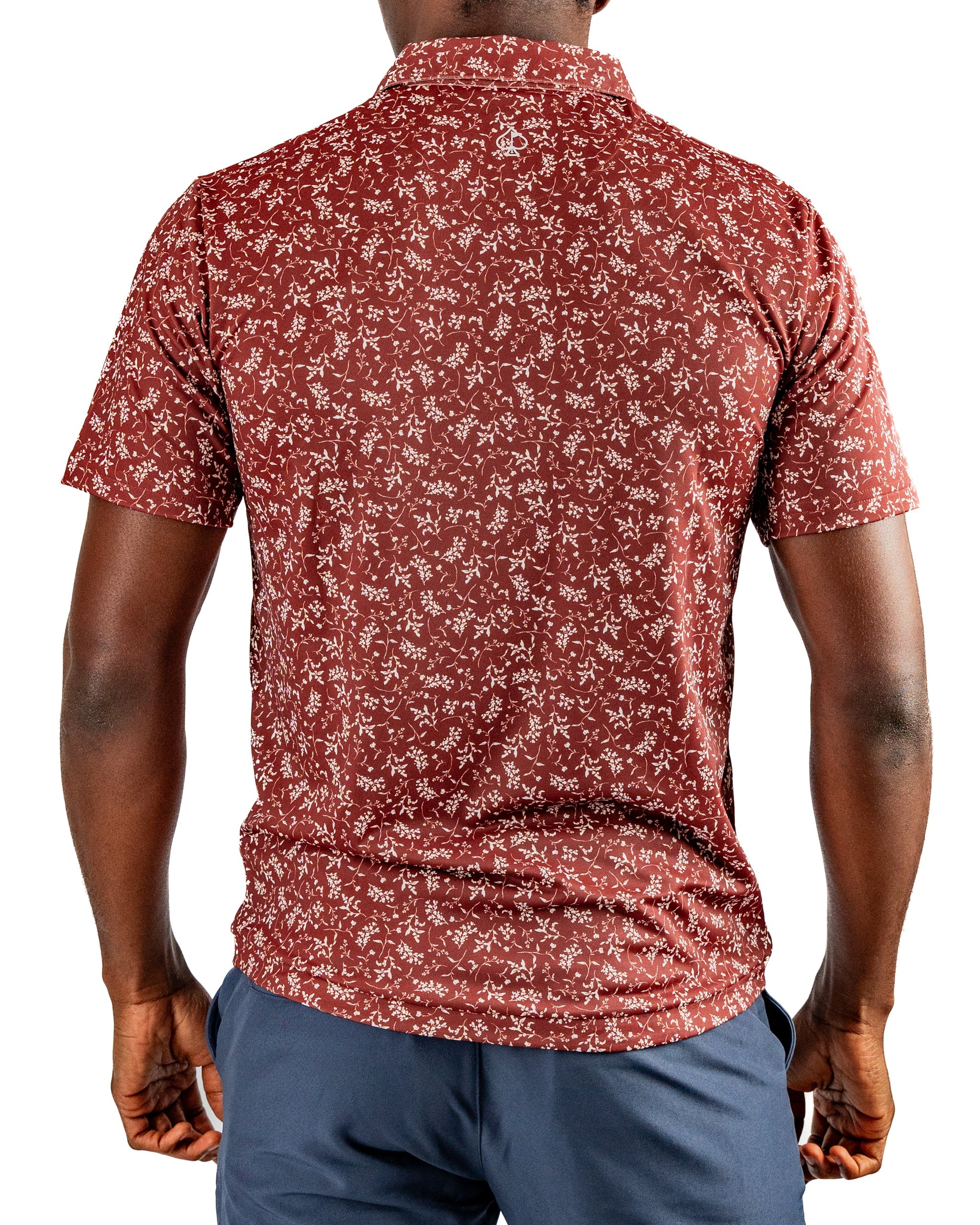 Men's short-sleeve golf shirt in burgundy with a floral pattern, designed for stylish performance on the course.