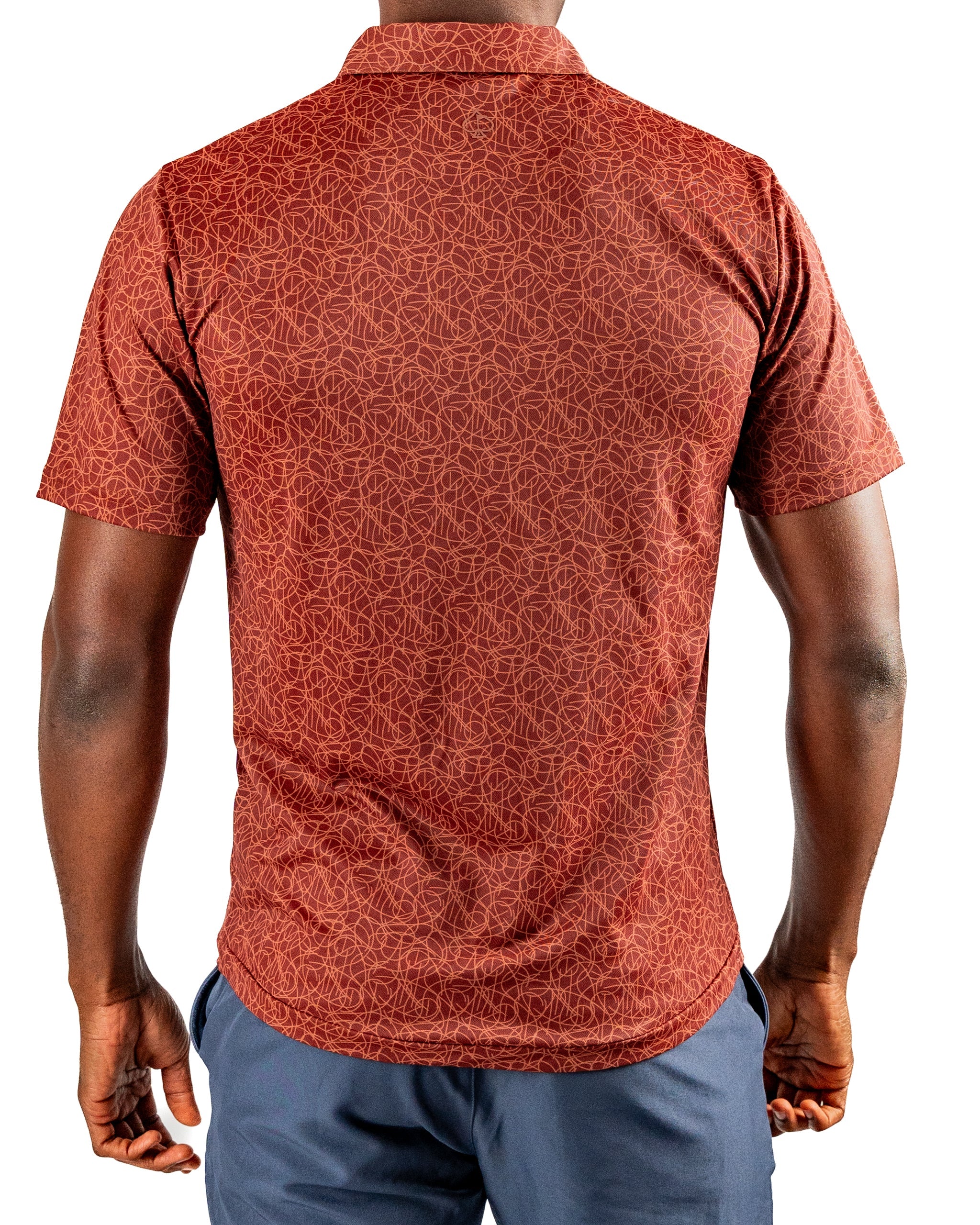 Men's short-sleeve golf shirt in a rich rust color featuring a geometric pattern, designed for bold style on the course.