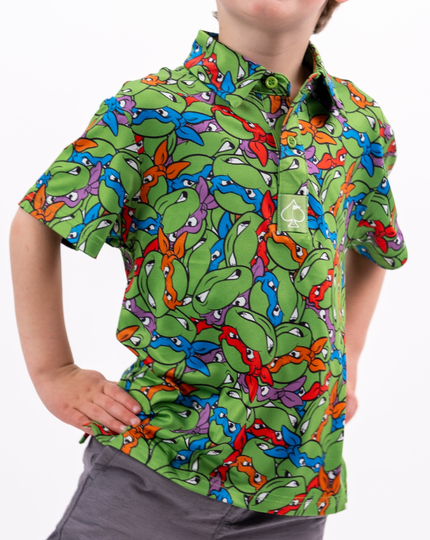 Colorful youth polo shirt featuring a vibrant Teenage Mutant Ninja Turtles design with green, blue, and orange hues.