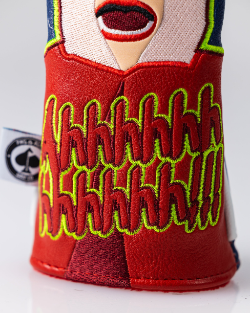 Bold golf headcover featuring a vibrant design with a screaming face and colorful "Aahhh!" text, perfect for standout style on the course.