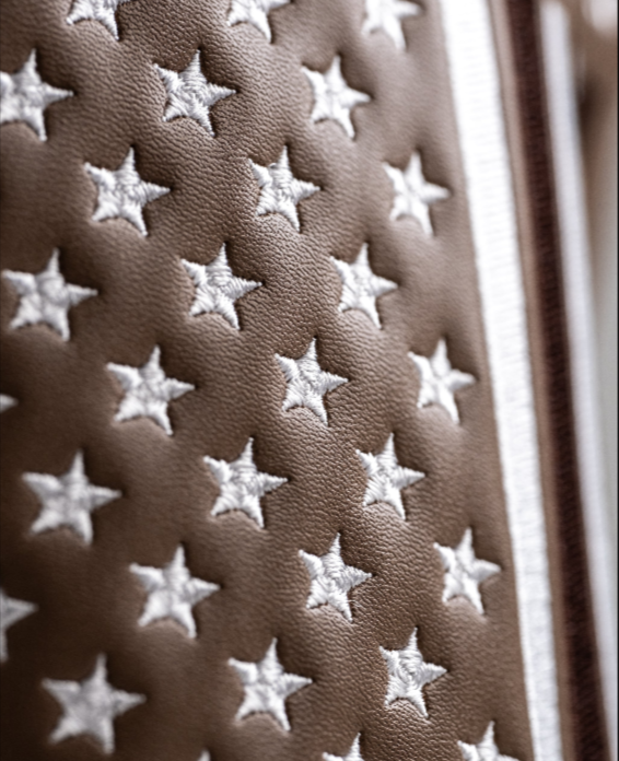Brown driver cover featuring a quilted star pattern, showcasing a patriotic design for golf enthusiasts.