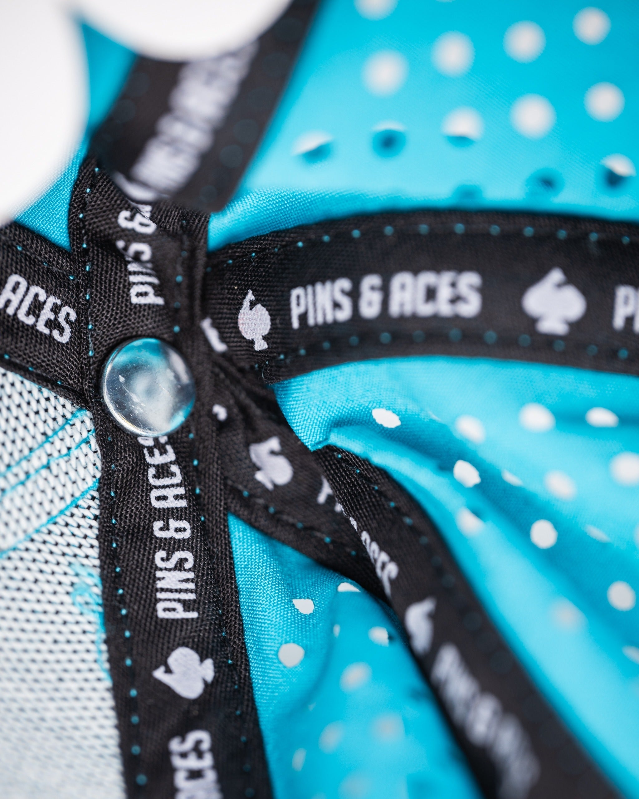 Perforated baby blue rope hat featuring a stylish interior lining with the Pins and Aces logo for a bold look.