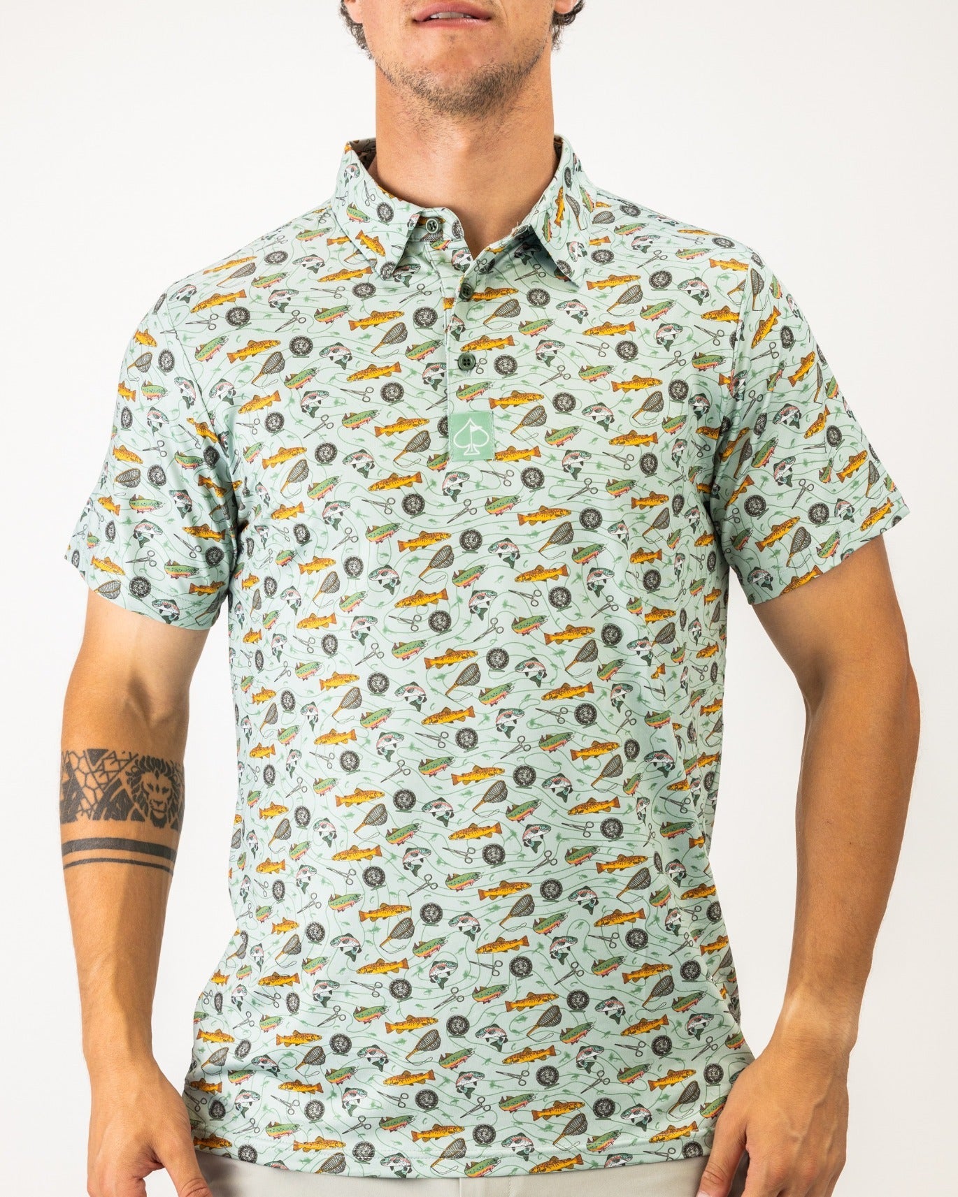 Men's short-sleeve golf polo featuring a playful fishing-themed pattern in mint green, perfect for stylish golfers.