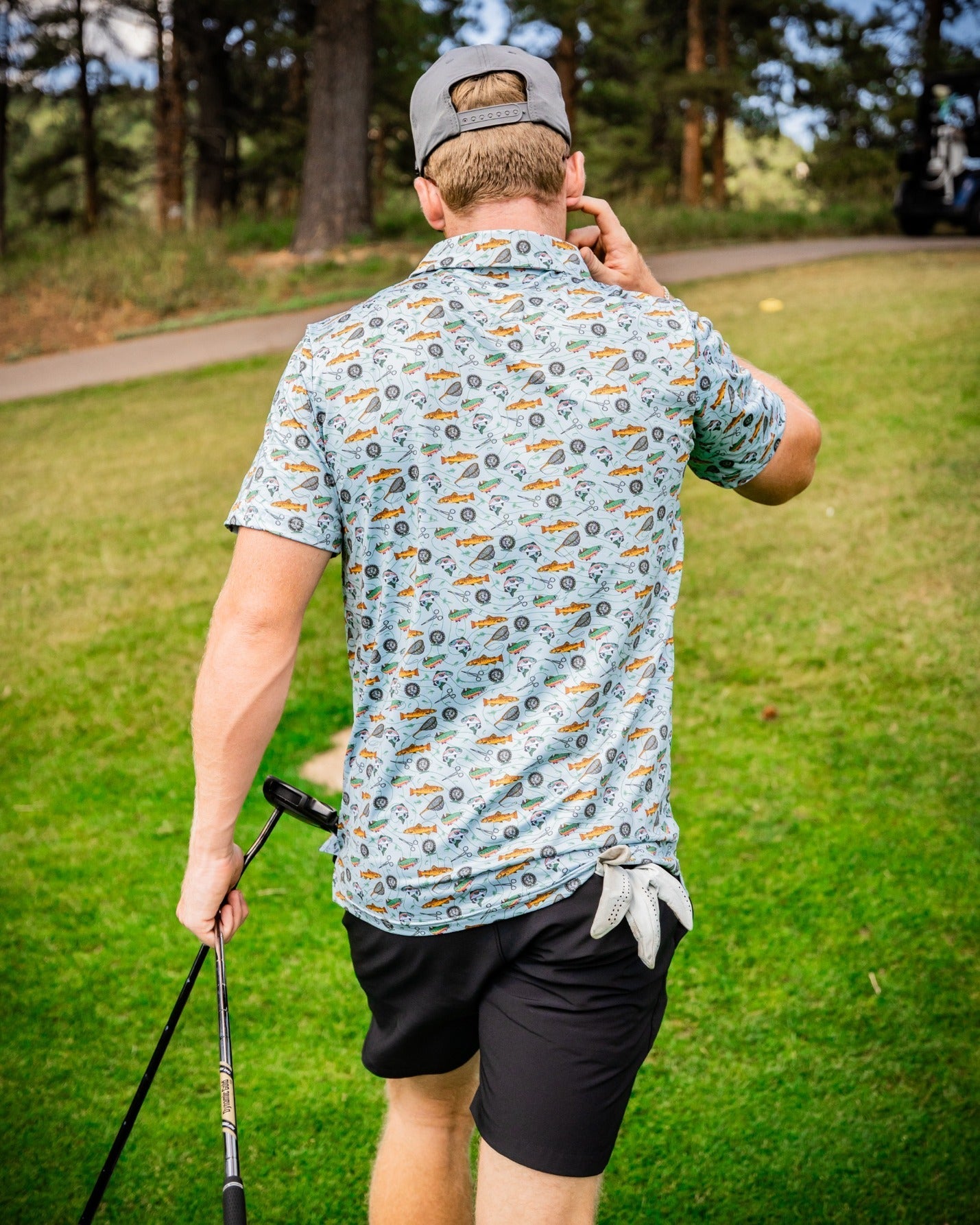Men's Catch and Release golf shirt featuring a playful fishing-themed print, perfect for stylish golfers on the course.