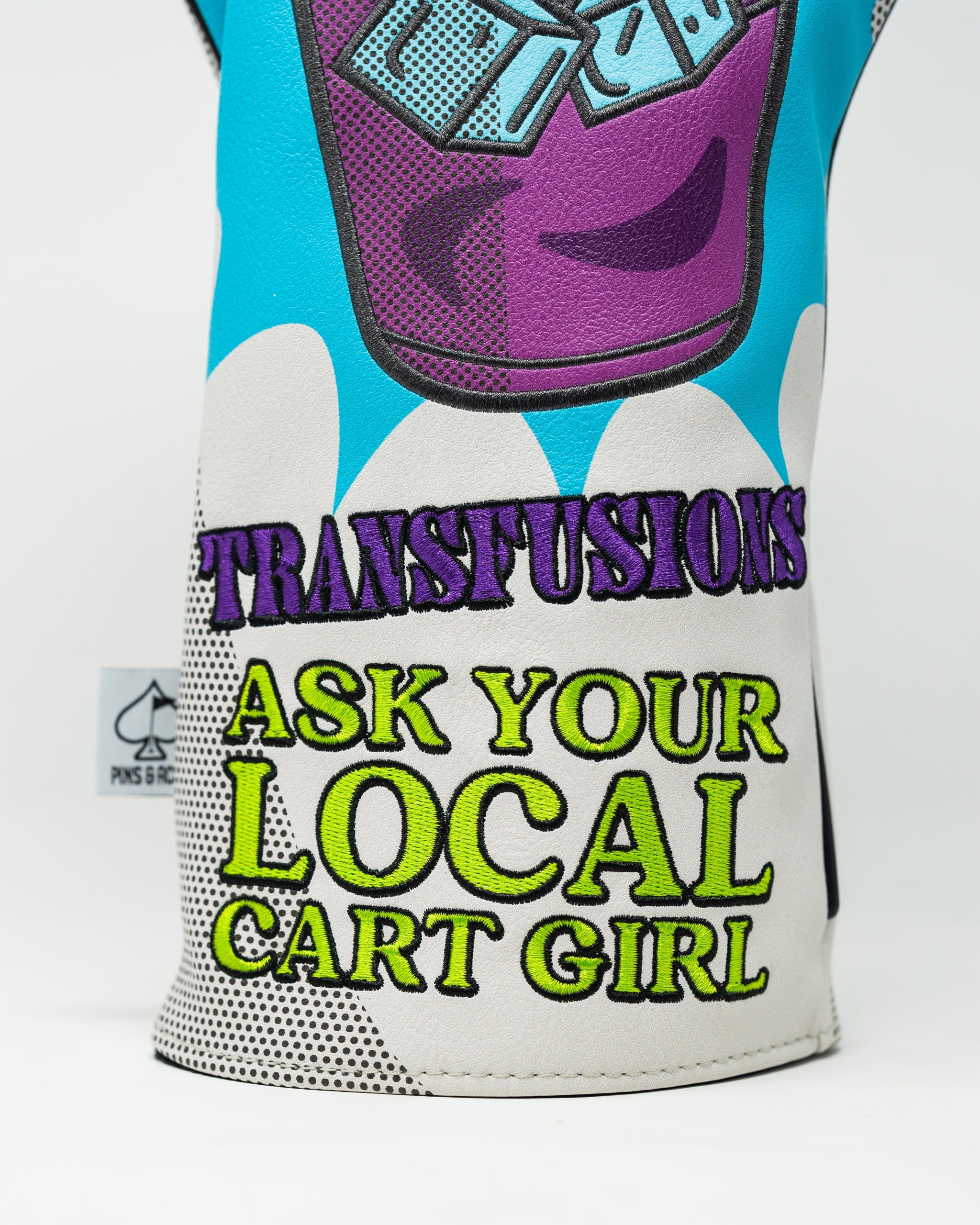 Bold golf driver cover featuring a colorful design with the text "Transfusions" and "Ask Your Local Cart Girl.