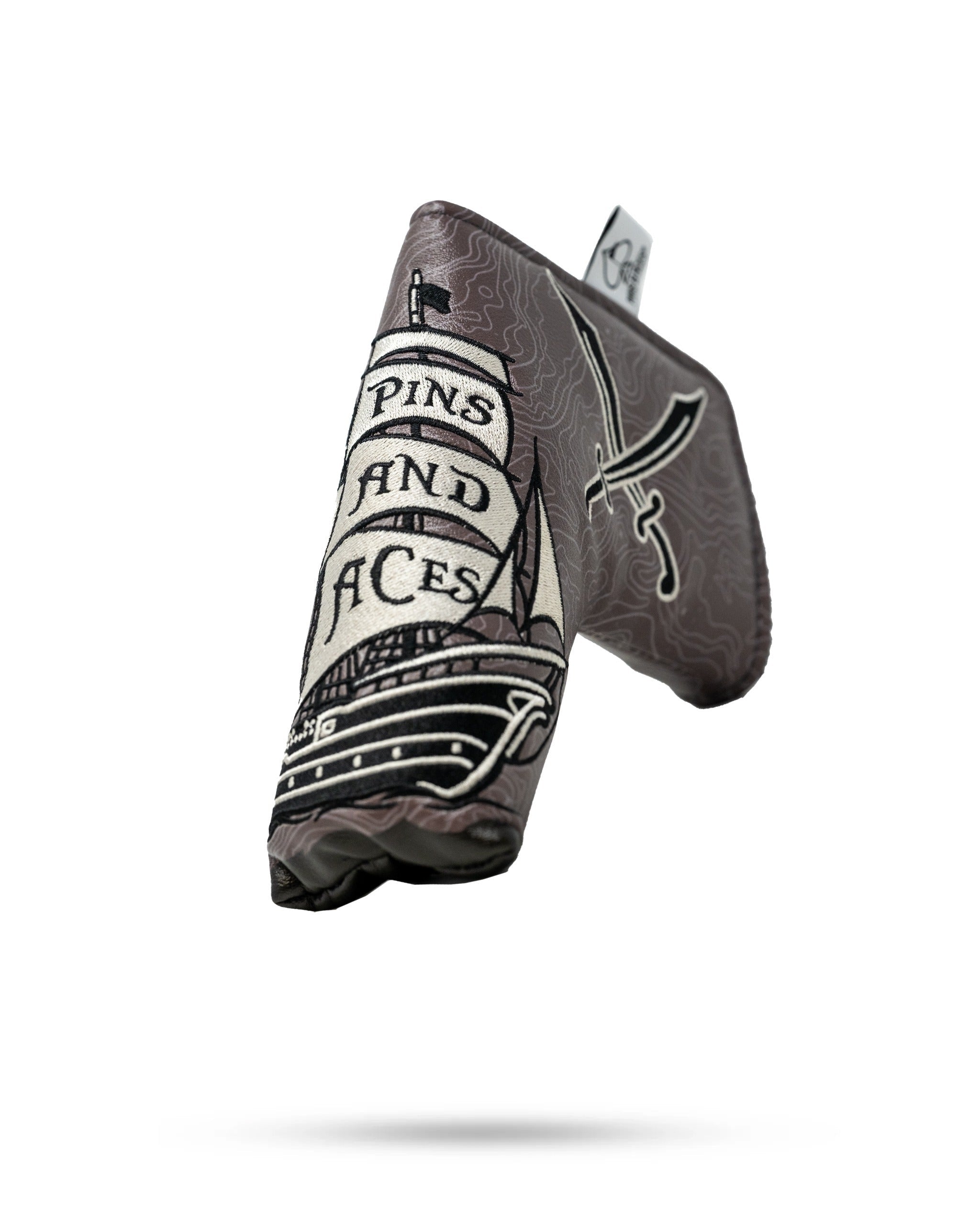 Bold pirate-themed blade putter cover featuring a ship and crossed swords, perfect for golfers wanting to stand out.