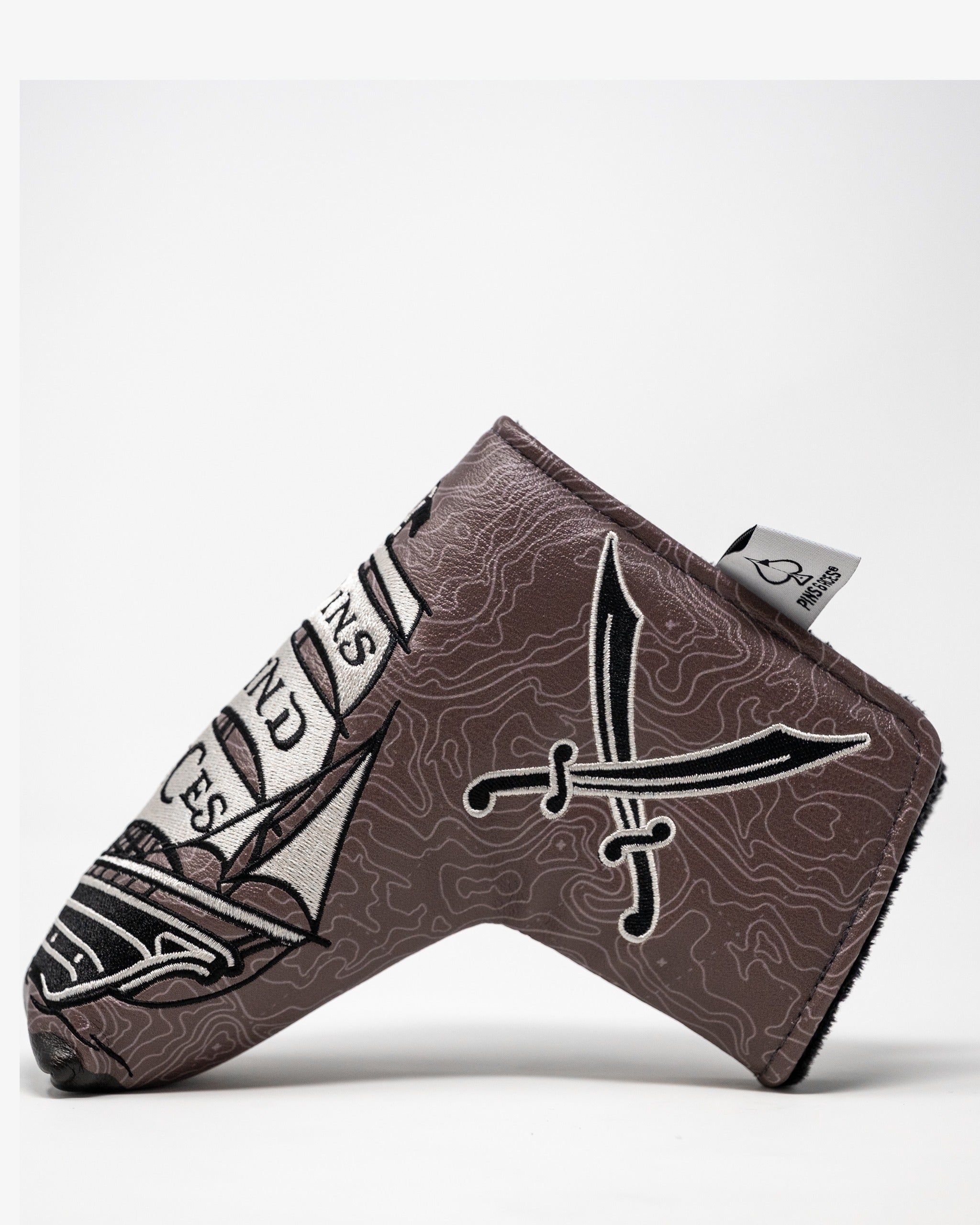 Bold pirate-themed blade putter cover featuring crossed swords and a unique design, perfect for stylish golfers.