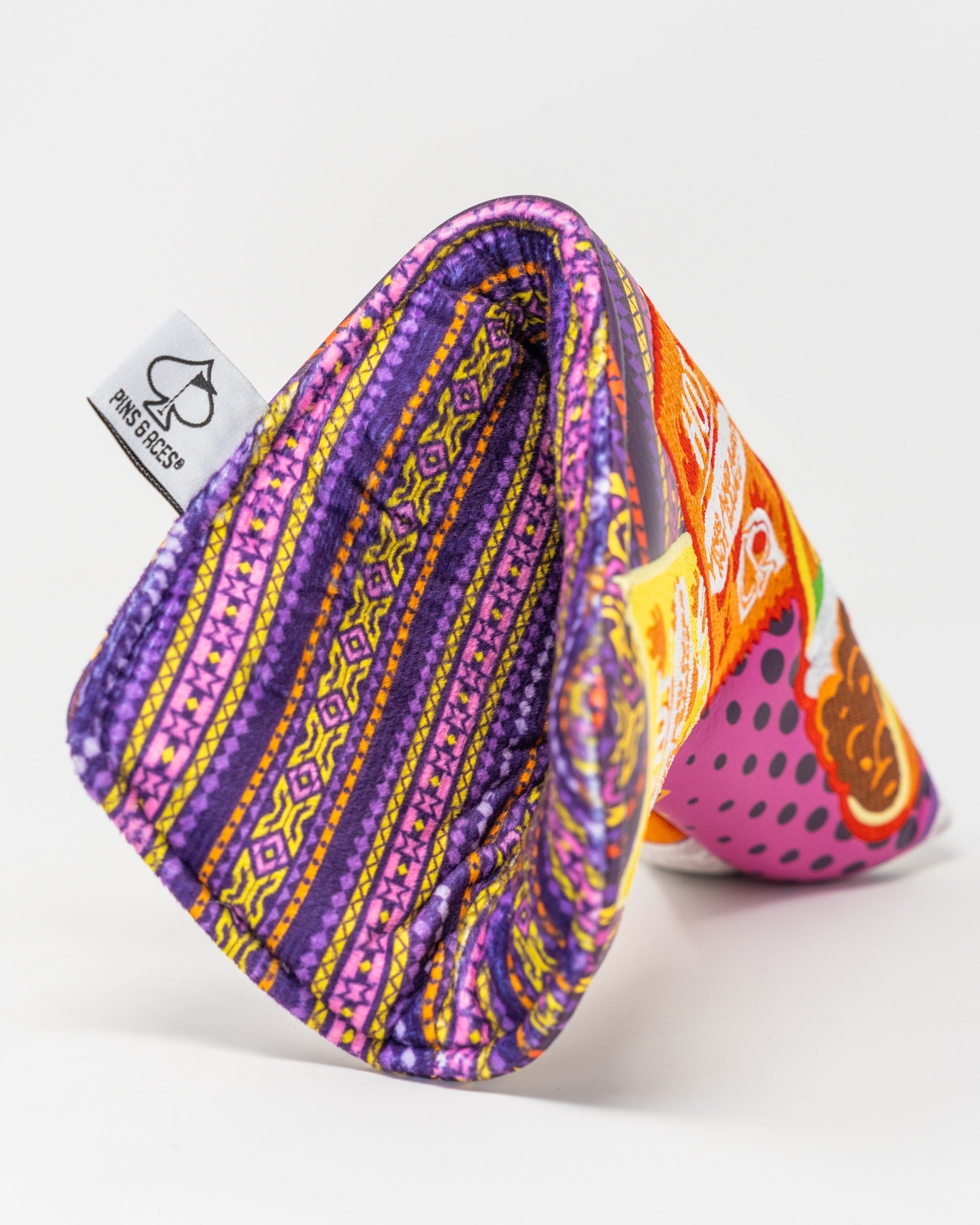 Vibrant blade putter cover featuring bold patterns and colors, designed to protect and enhance your golf gear.