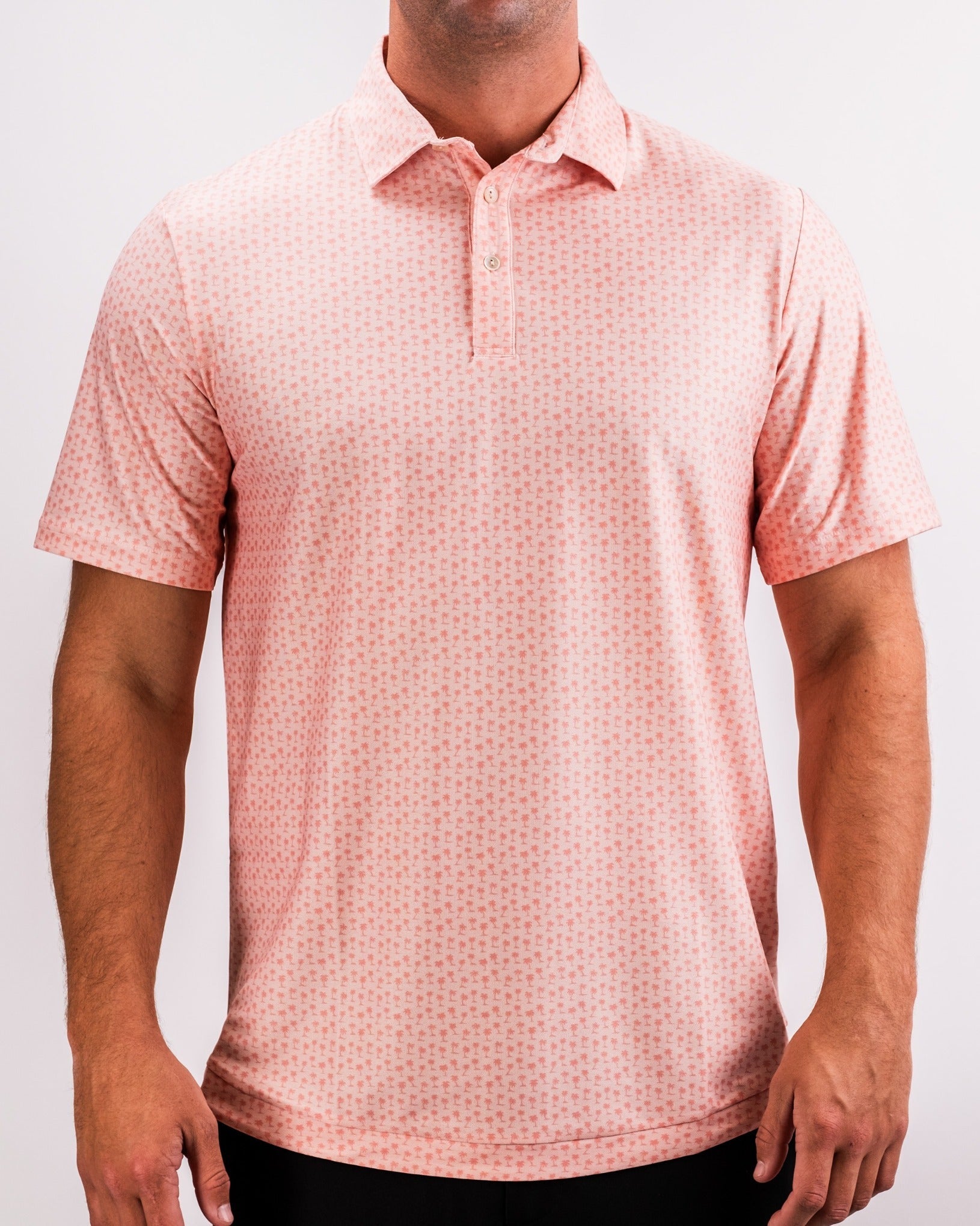 Men's Player Preferred Polo in Coral Palms features a vibrant coral color with a subtle palm pattern, ideal for stylish golf outings.