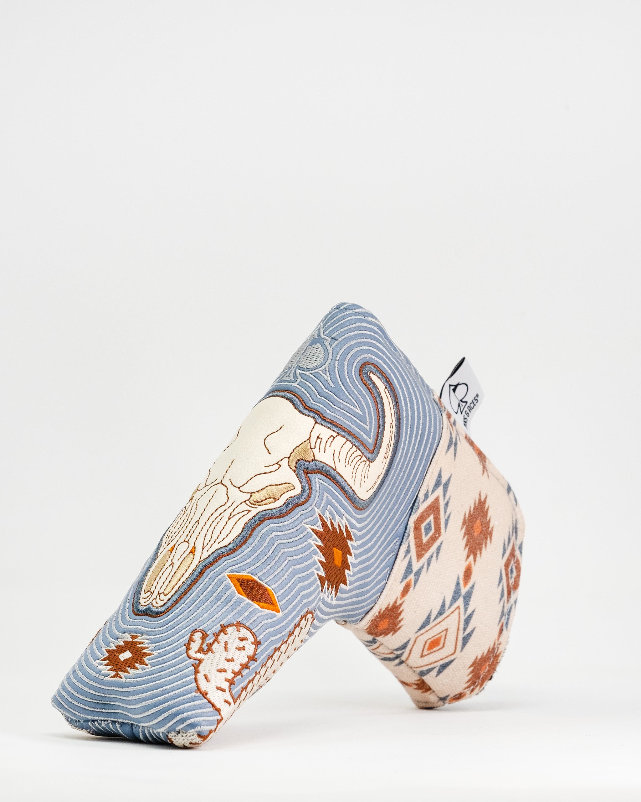 Western aesthetic blade putter cover featuring a unique design with a skull, cacti, and geometric patterns. Perfect for stylish golfers.