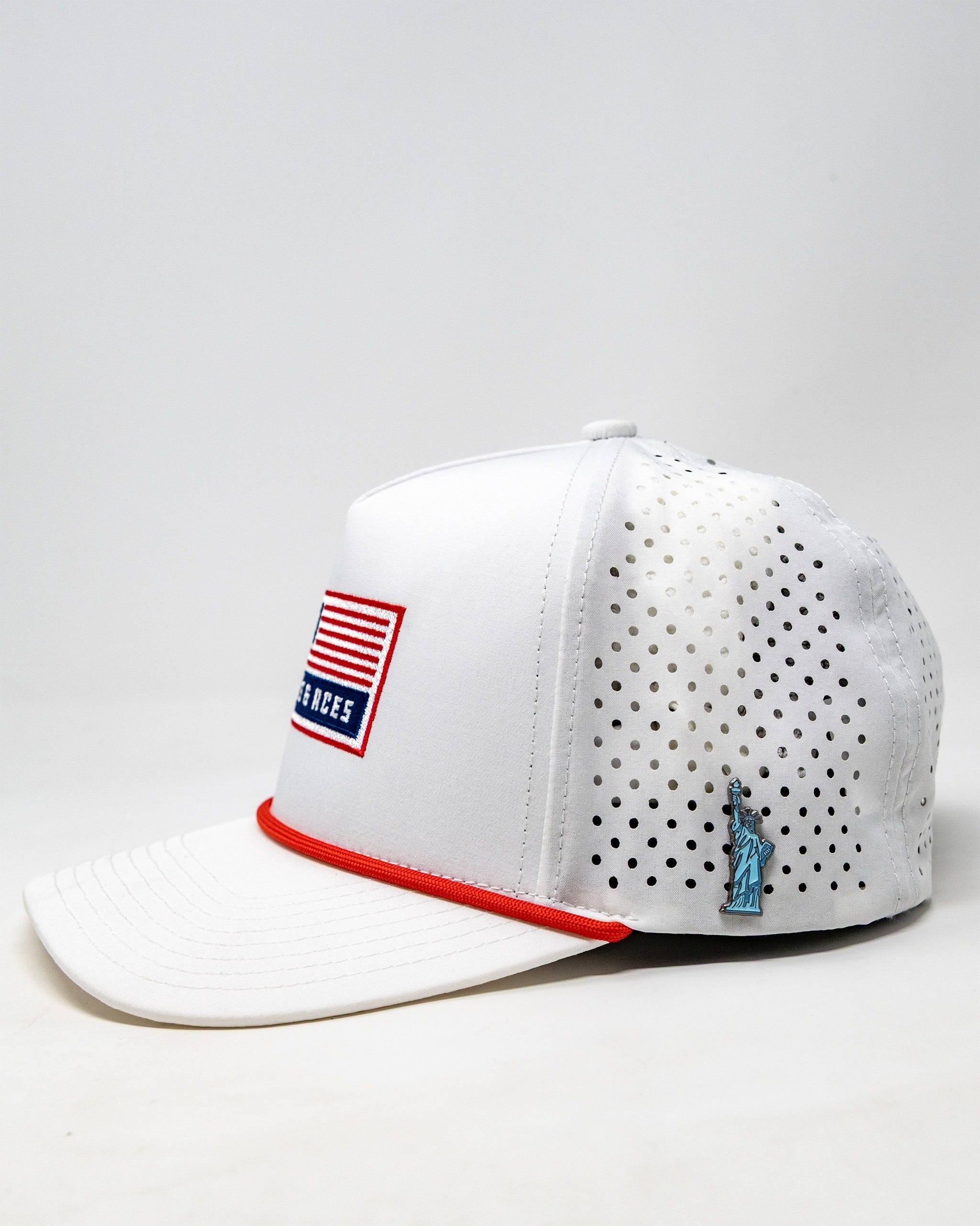 Perforated white rope hat featuring a USA flag patch and a small Statue of Liberty emblem on the side.