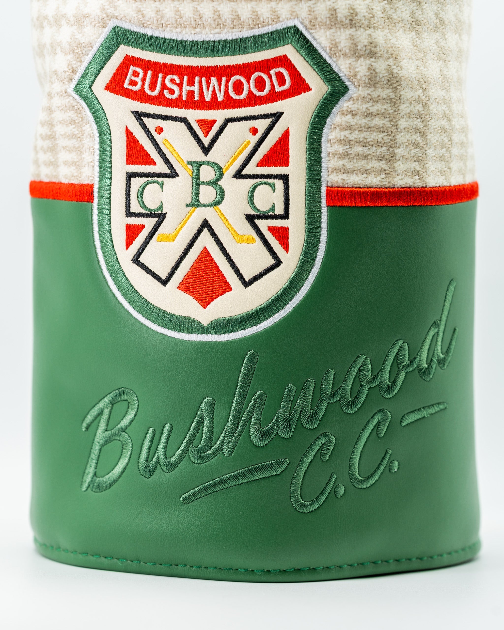 Bushwood CC driver cover featuring a classic design with a green leather base and embroidered logo for stylish golf protection.