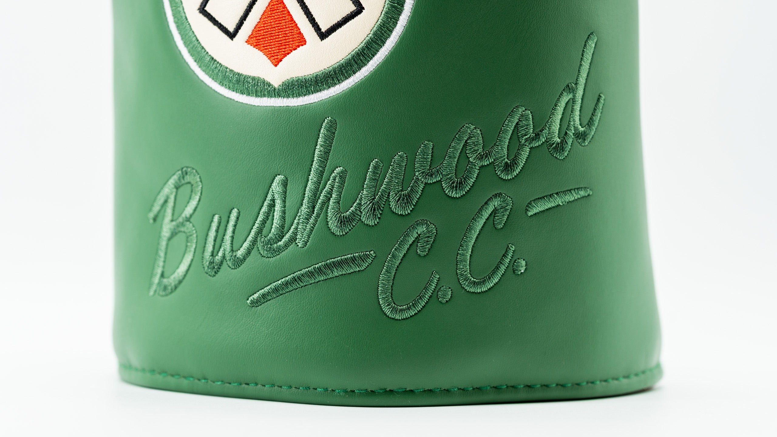 Bushwood CC driver cover featuring bold green leather and elegant embroidered lettering for a stylish golf accessory.
