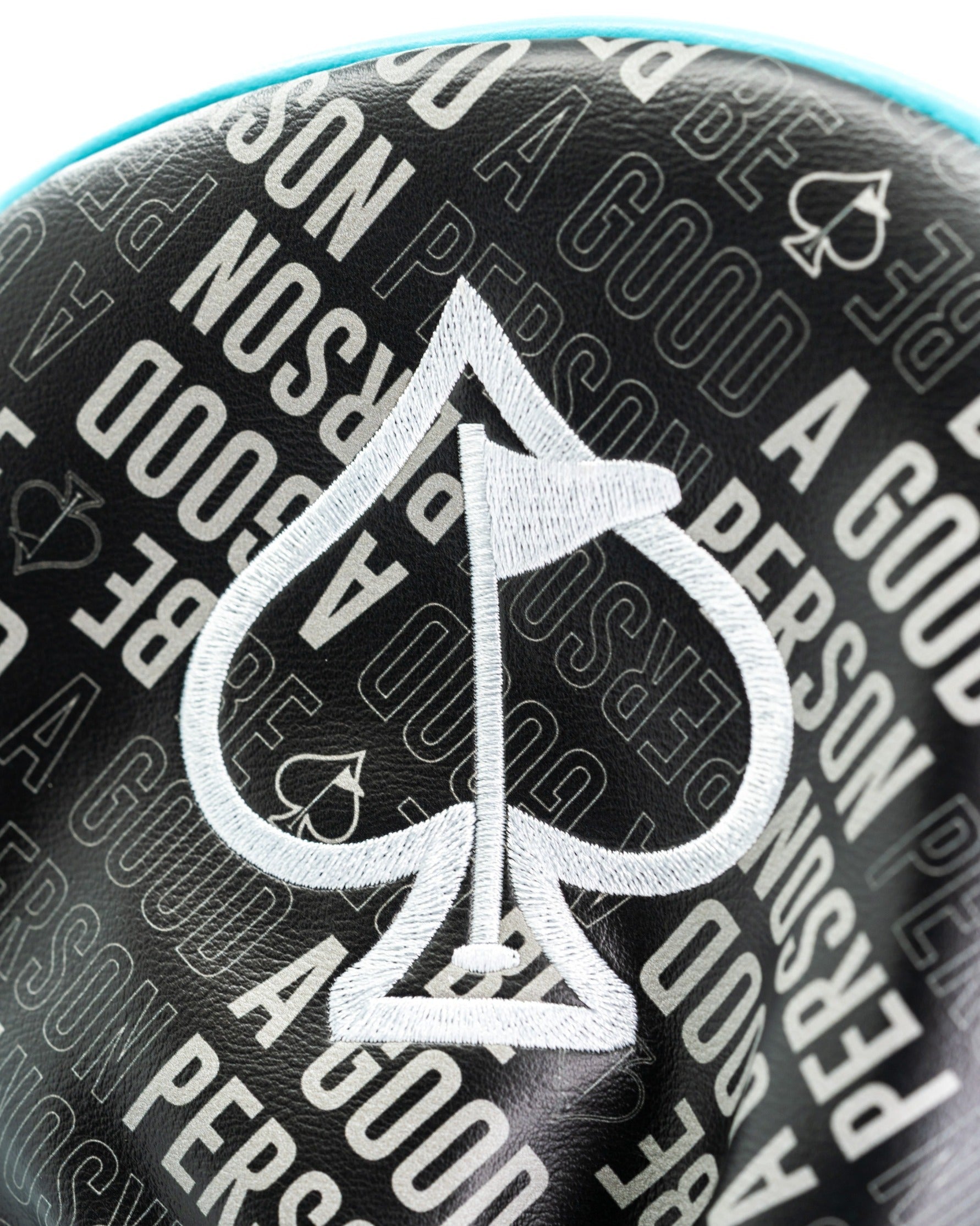 Bold driver cover featuring a spade design and the phrase "Be A Good Person" in a stylish pattern for standout golf style.