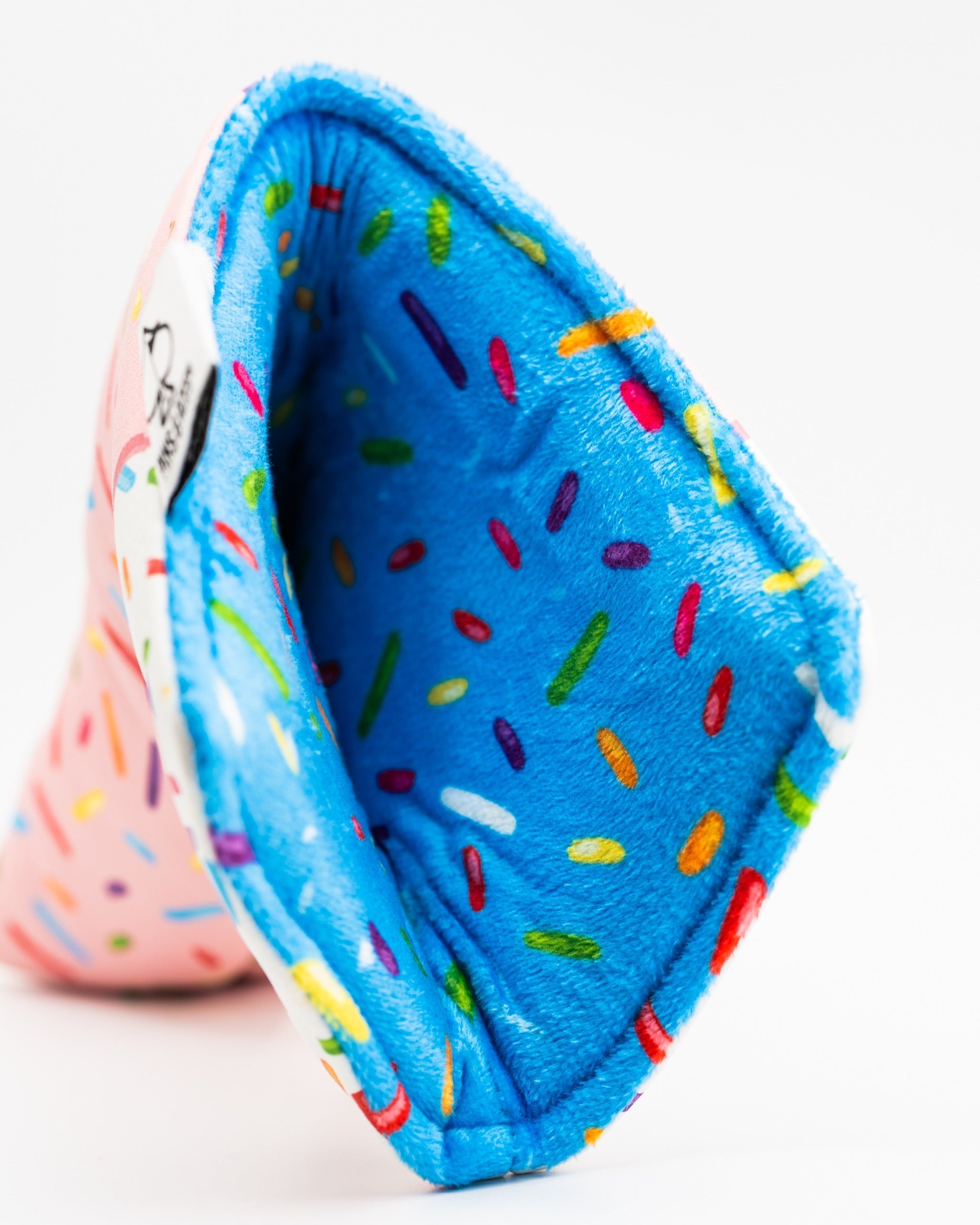 Colorful blade putter cover featuring a pink exterior with a fun donut design and a bright blue interior with sprinkles.
