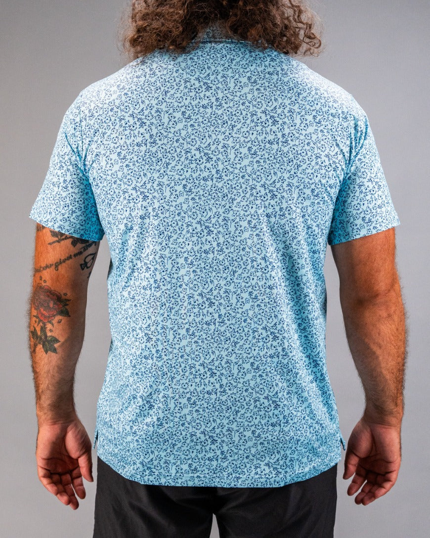 Men's blue golf shirt featuring a flower doodle pattern, designed for stylish comfort on the course.
