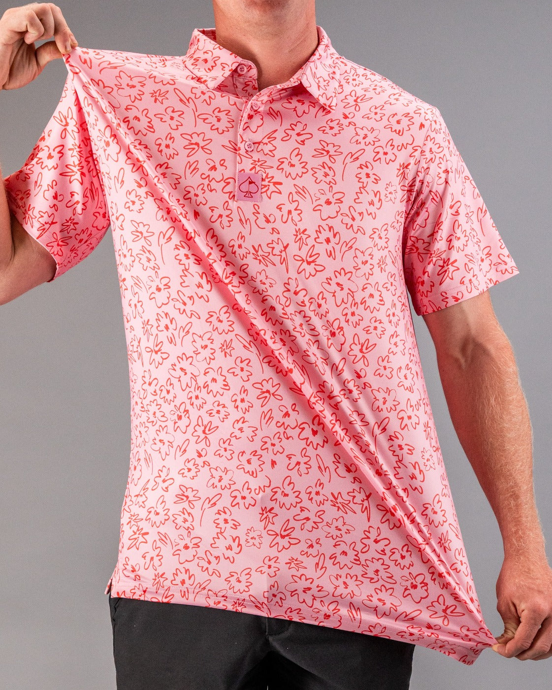 Men's pink golf polo shirt featuring a vibrant flower doodle pattern, perfect for stylish golfers on the course.