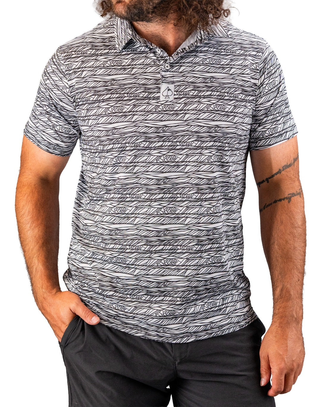 Men's Fragment Black golf polo featuring a bold, abstract pattern in black and white, perfect for a standout look on the course.