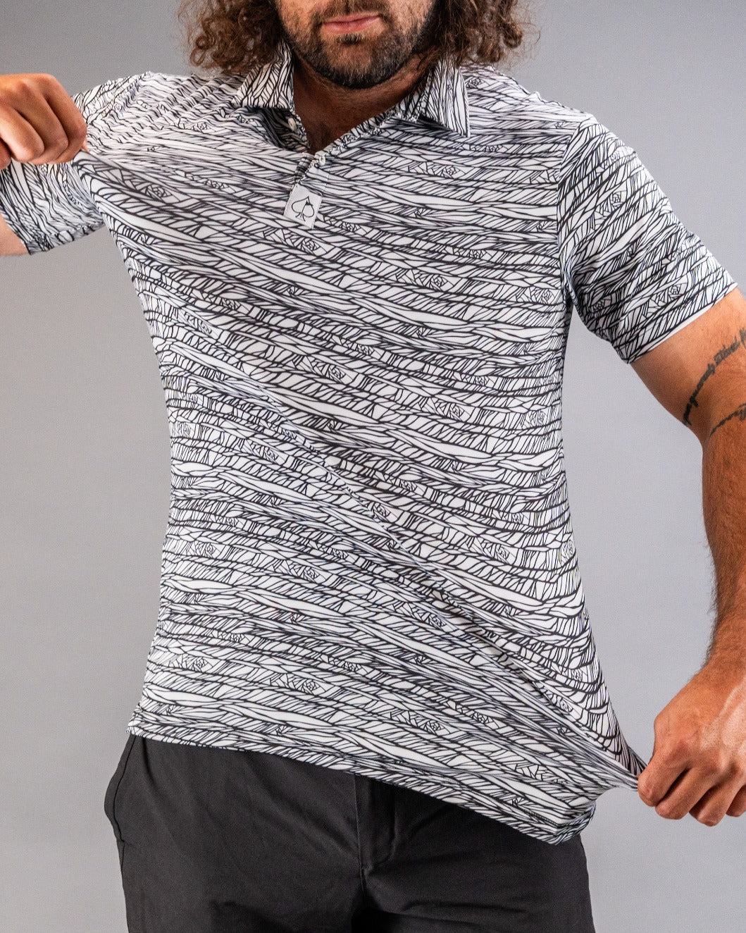 Bold black and white patterned golf polo shirt, showcasing a unique design ideal for stylish golfers on the course.