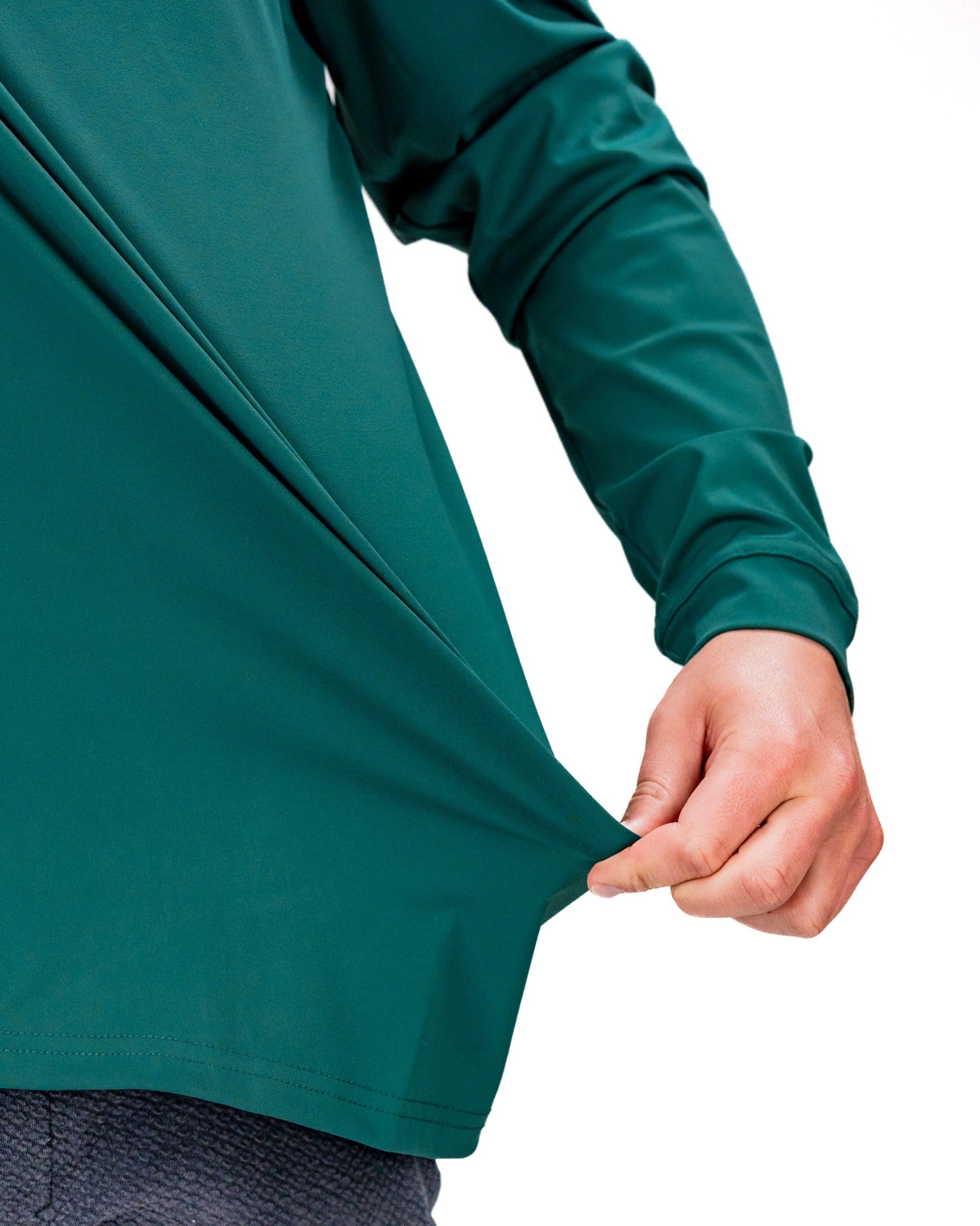 Performance Golf Hoodie in Tiger Shatter Teal, showcasing a close-up of the fabric and fit with a hand pulling the hem.