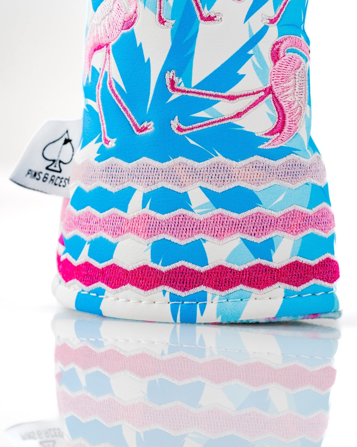 Colorful hybrid golf cover featuring a vibrant flamingo pattern and textured stitching, designed for stylish golfers.