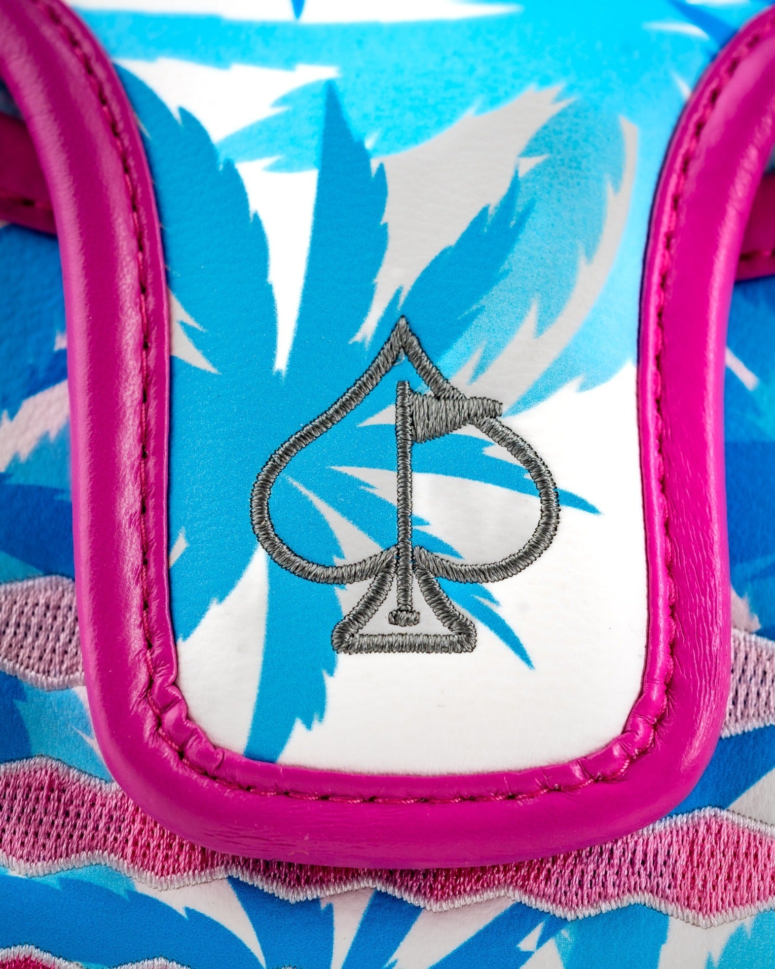 Brightly colored flamingo-patterned mallet putter cover featuring a pink trim and spade logo, perfect for stylish golfers.