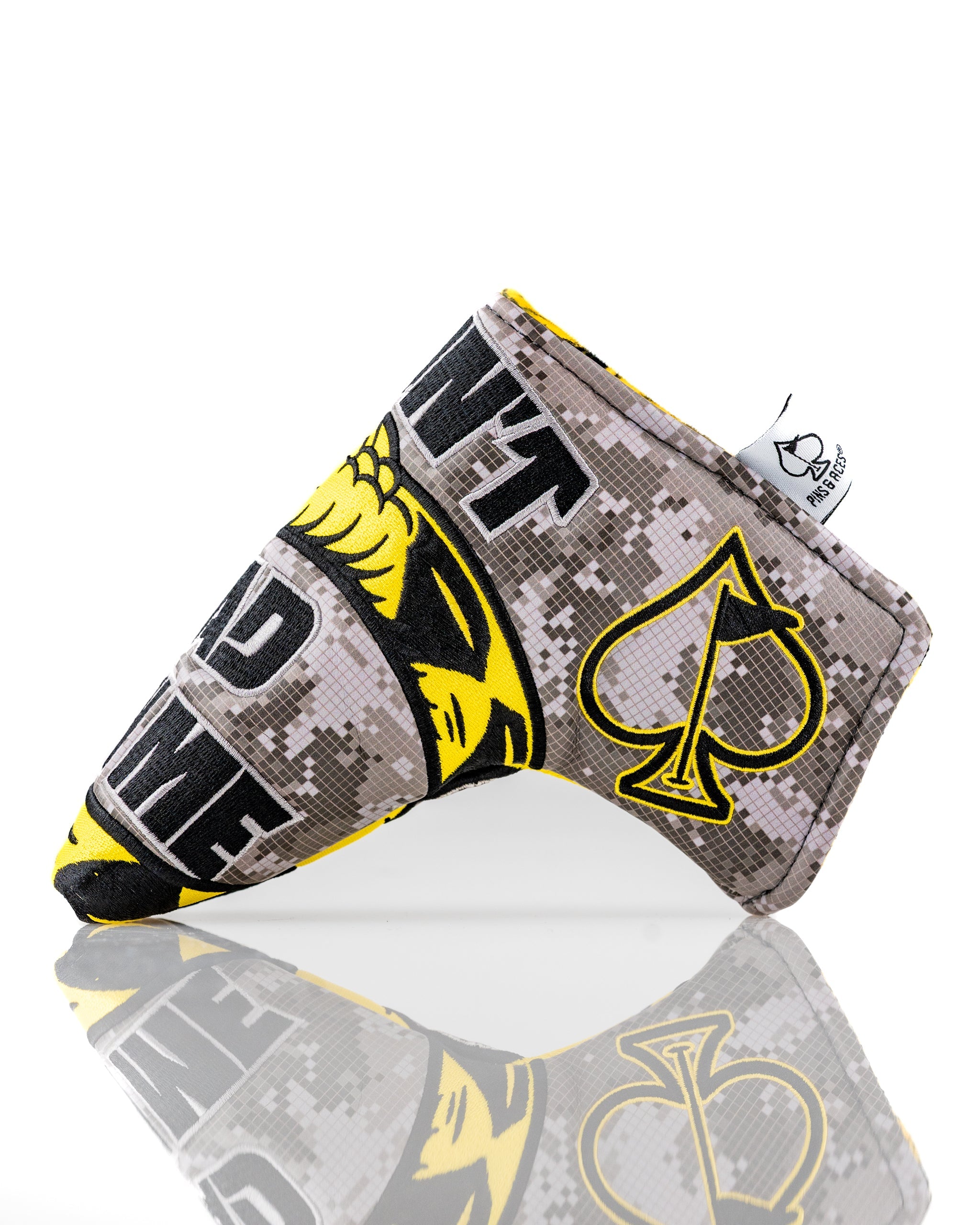 Bold Don't Tread On Me 2.0 blade putter cover featuring a camouflage design and striking yellow accents for golfers.