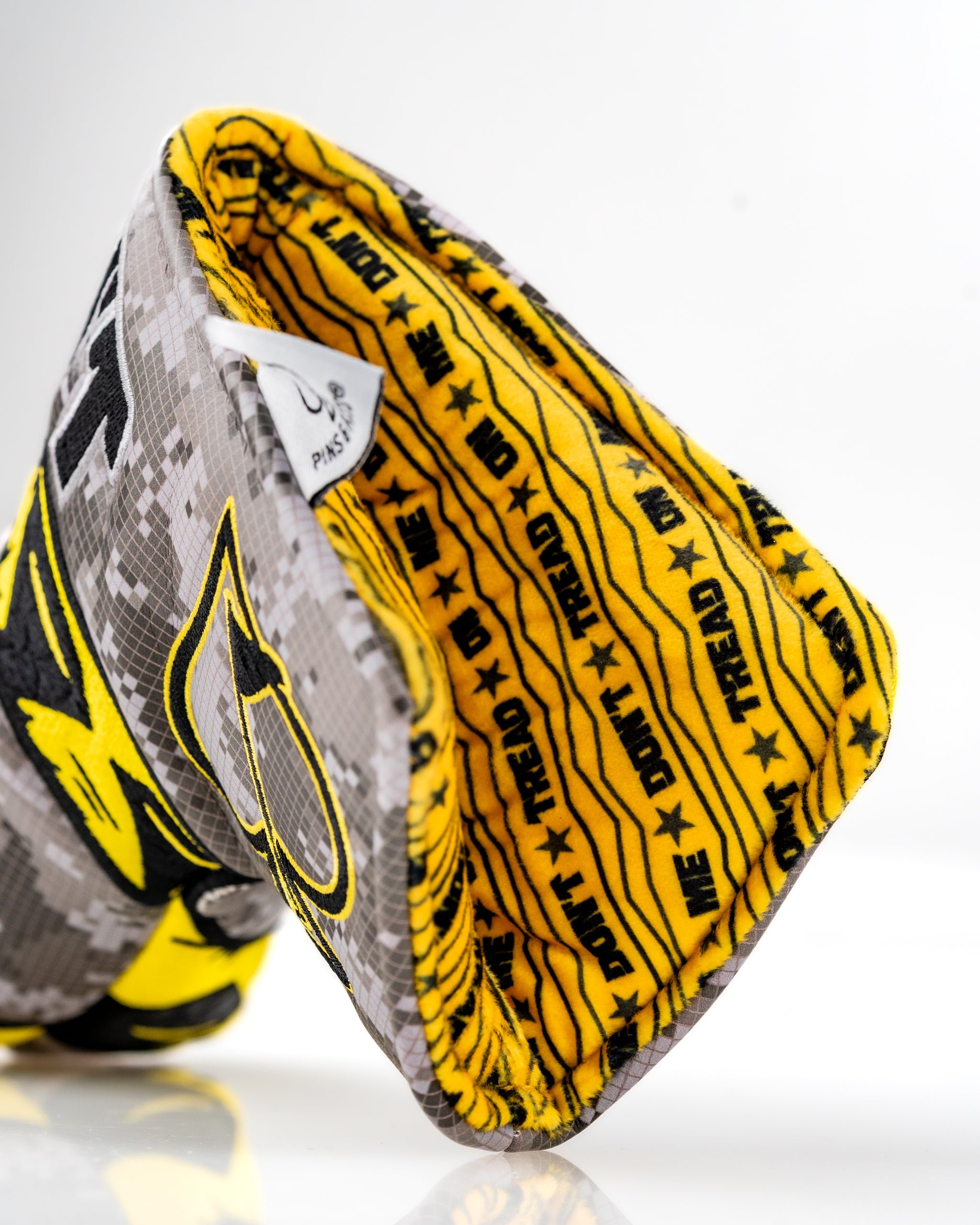 Bold Don't Tread On Me 2.0 blade putter cover featuring a striking yellow interior and camouflage exterior design.
